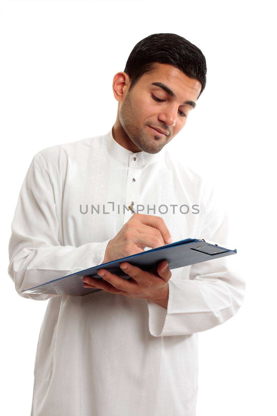 An ethnic businessman in traditional clothing, holding a clipboard folder and writing with a pen.  White background.
