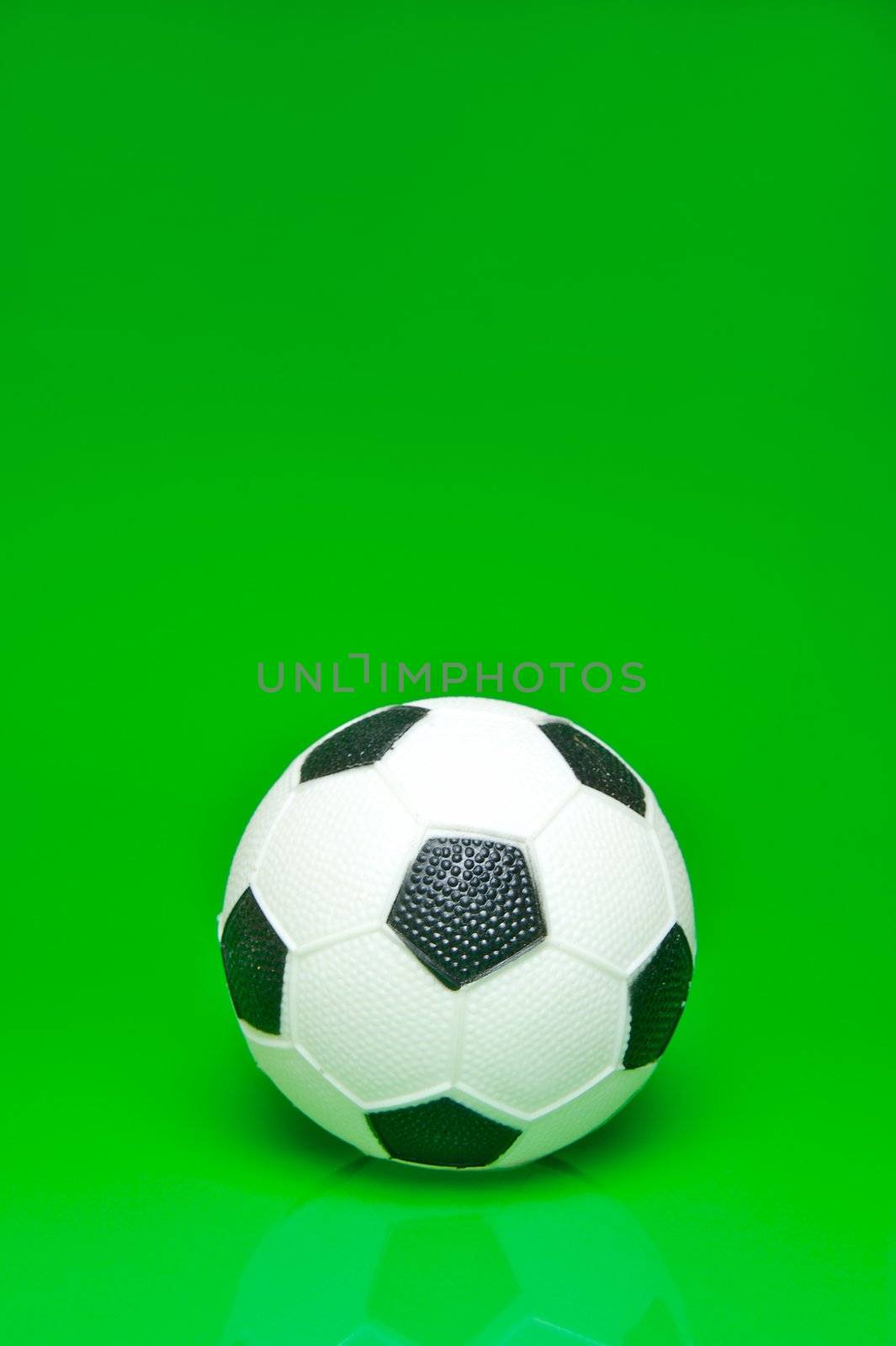 A soccer ball isolated against a green background