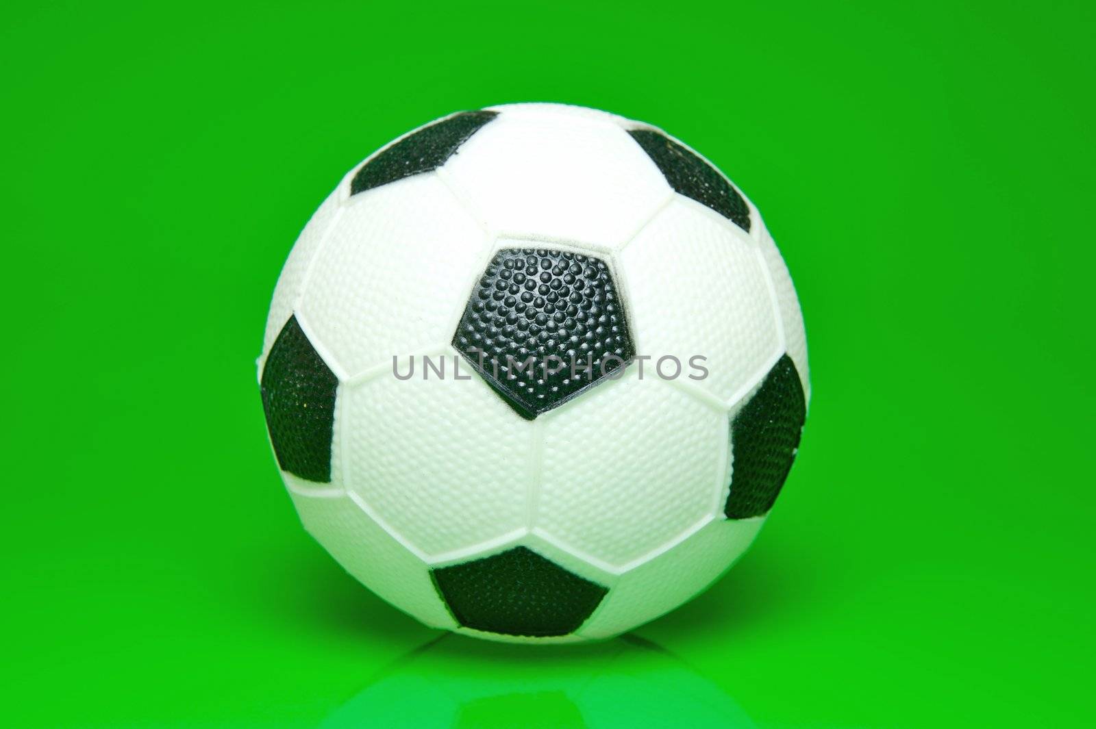 A soccer ball isolated against a green background