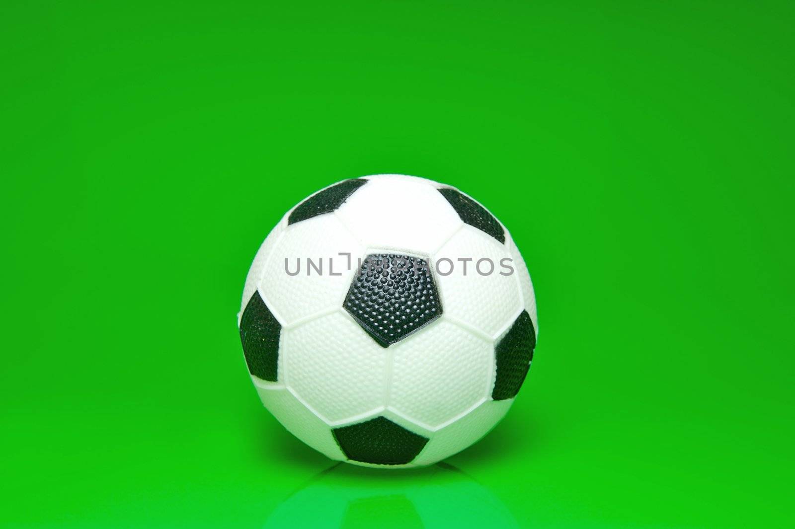 A soccer ball isolated against a green background