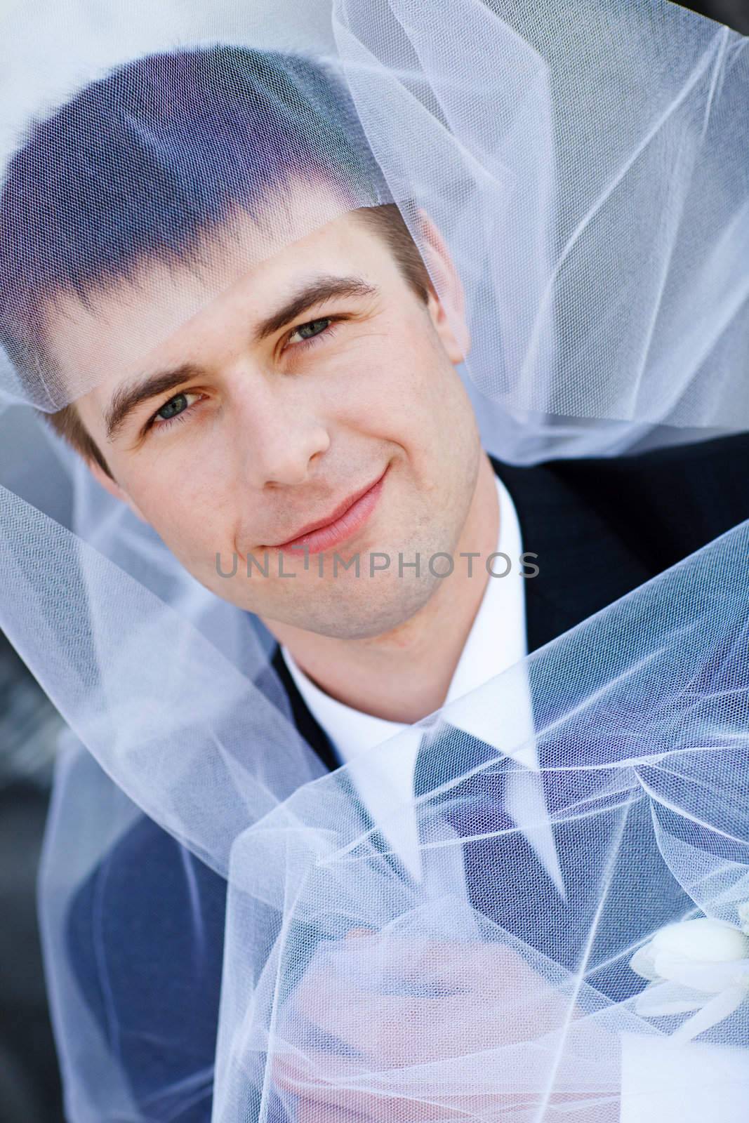 young groom and veil