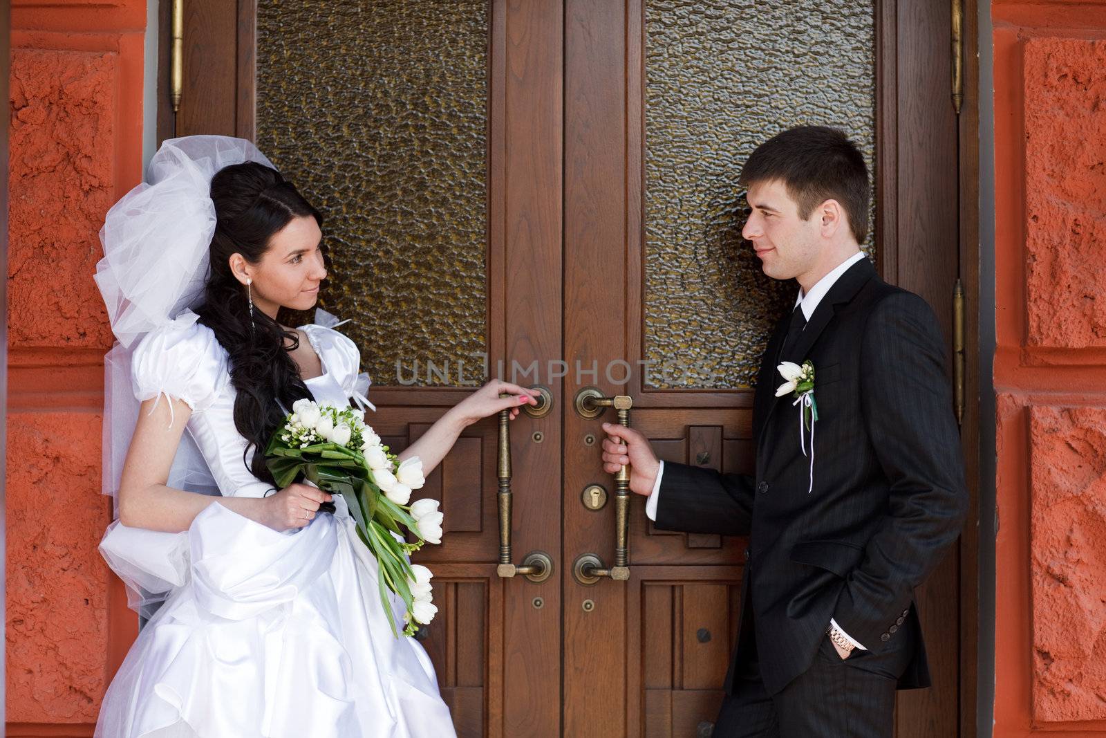 bride and groom near the door