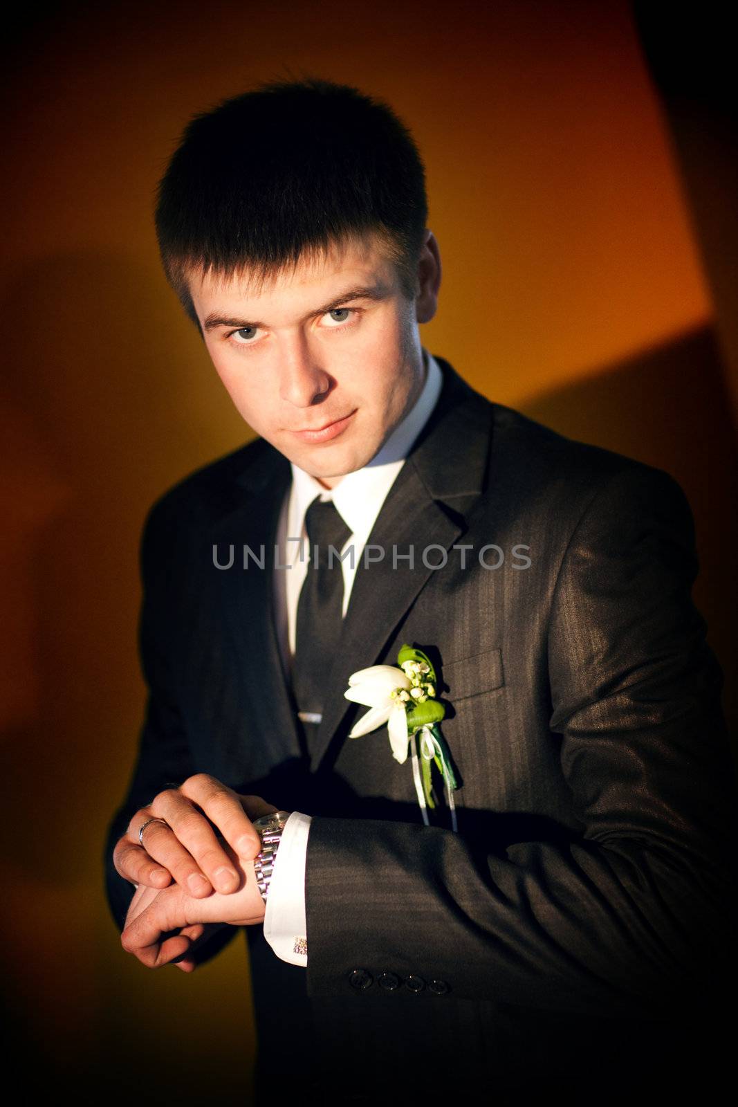 a groom with watch indoors