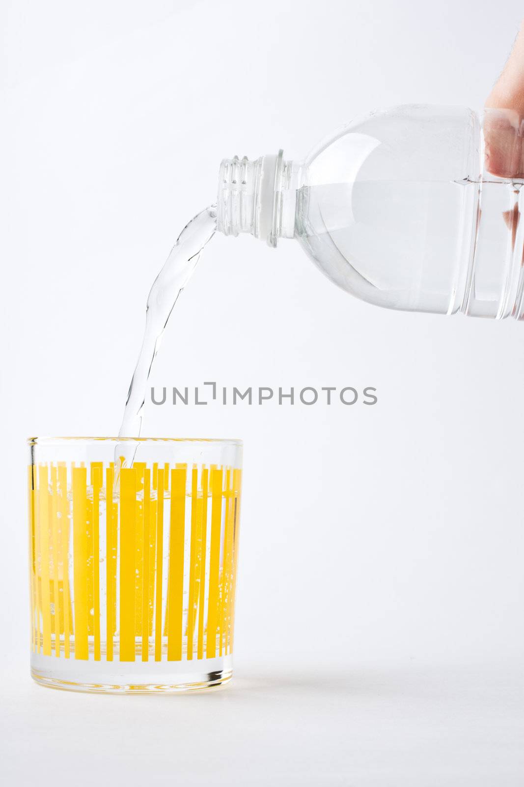 Fill glass of mineral water from bottle