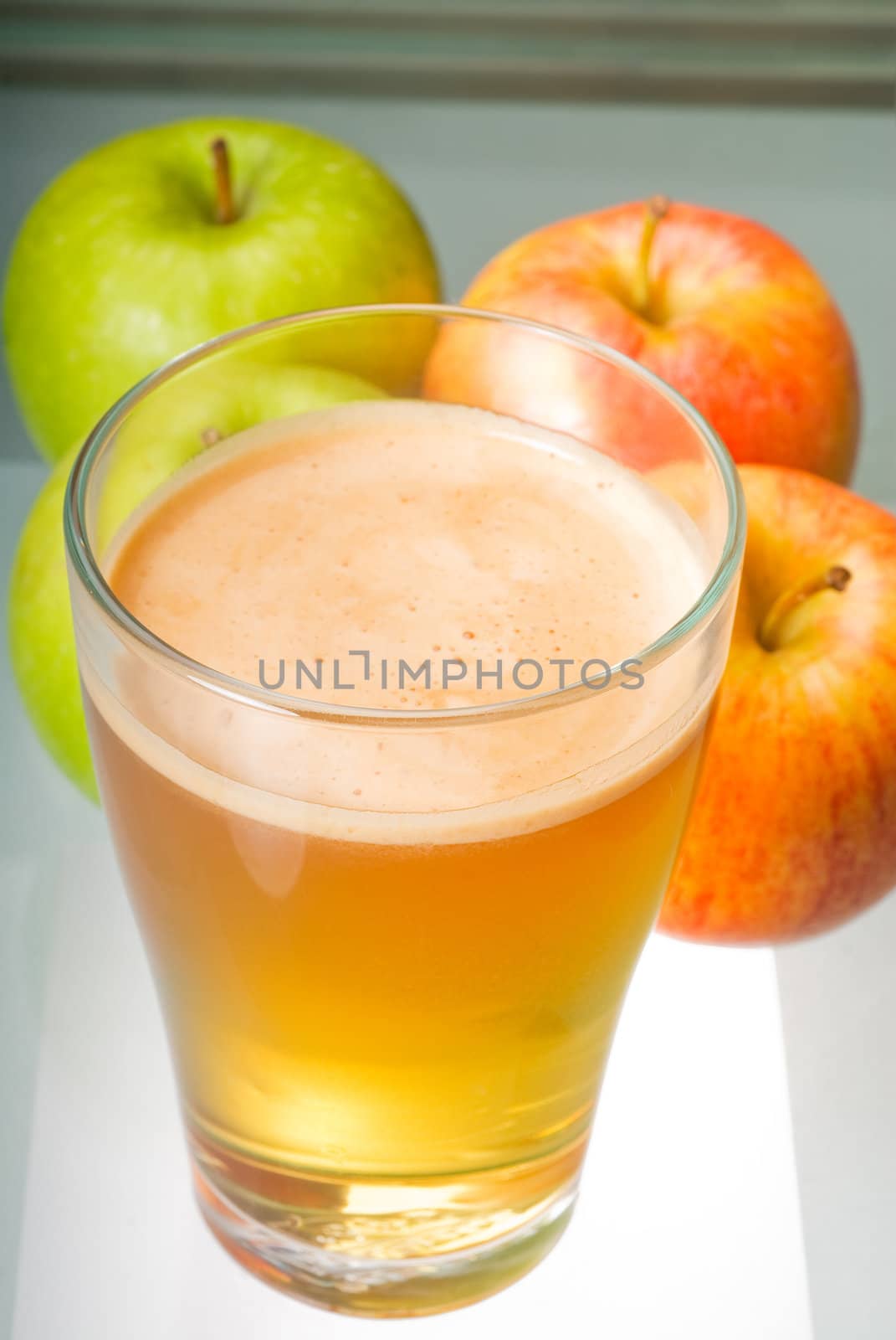 fresh  and healty natural apple  juice unfiltered , backlit on a light table