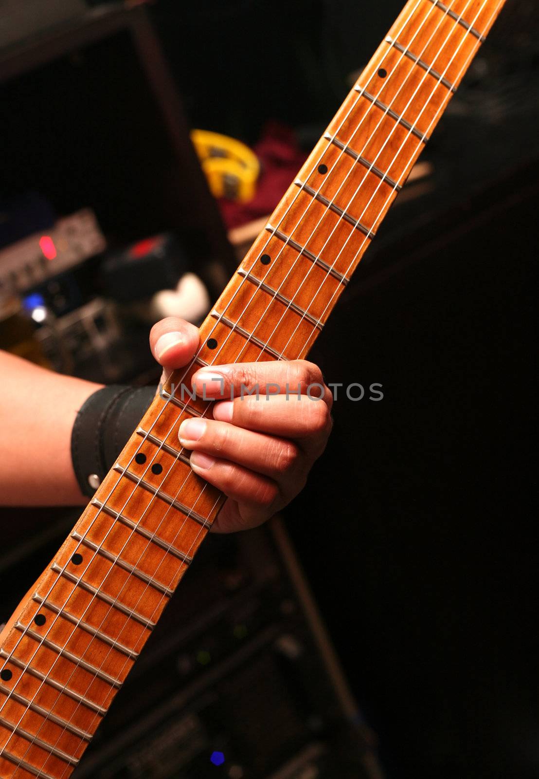 Details of a rockgig. Man's hand and guitar
