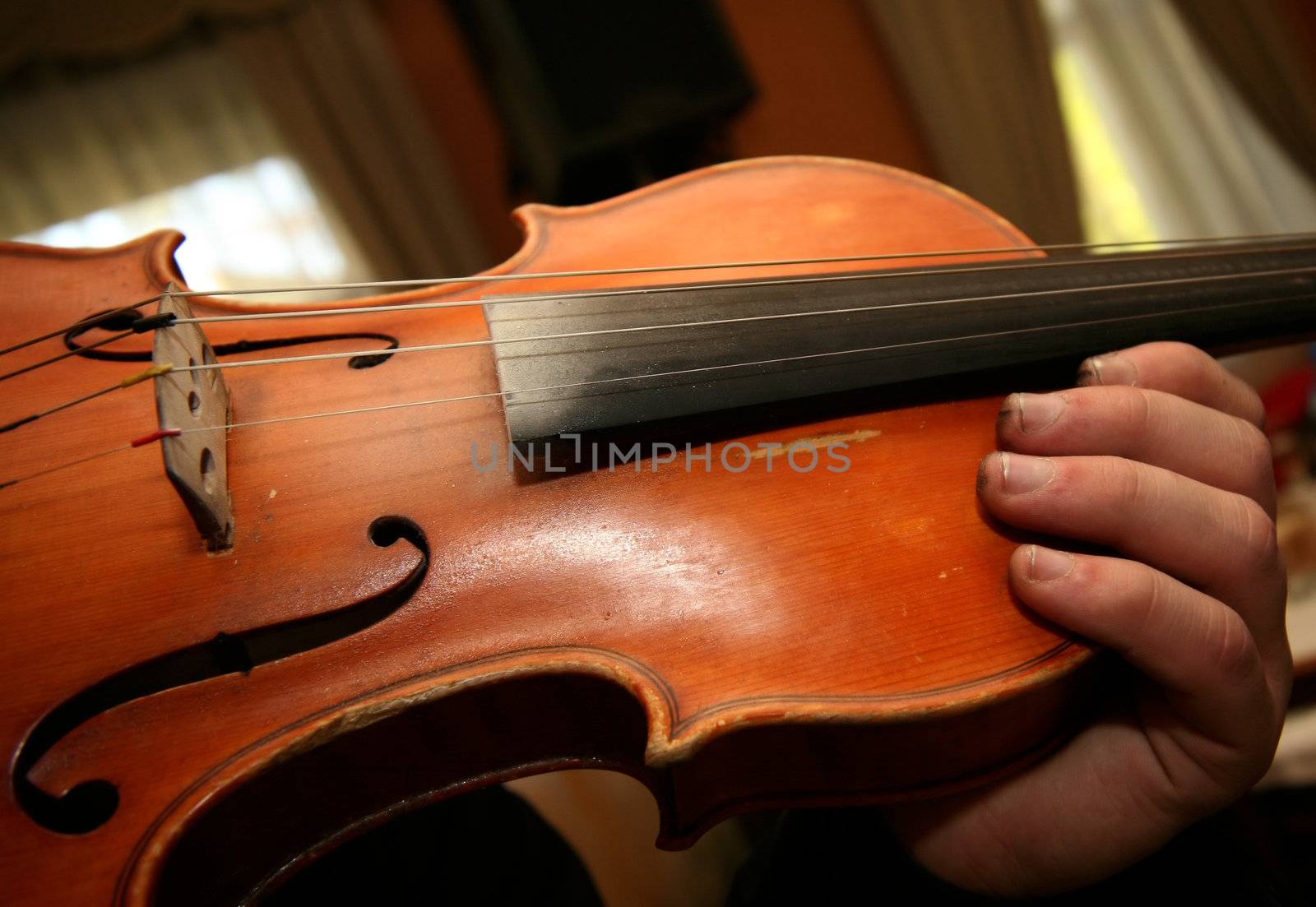 The person plays on a violin at restaurant