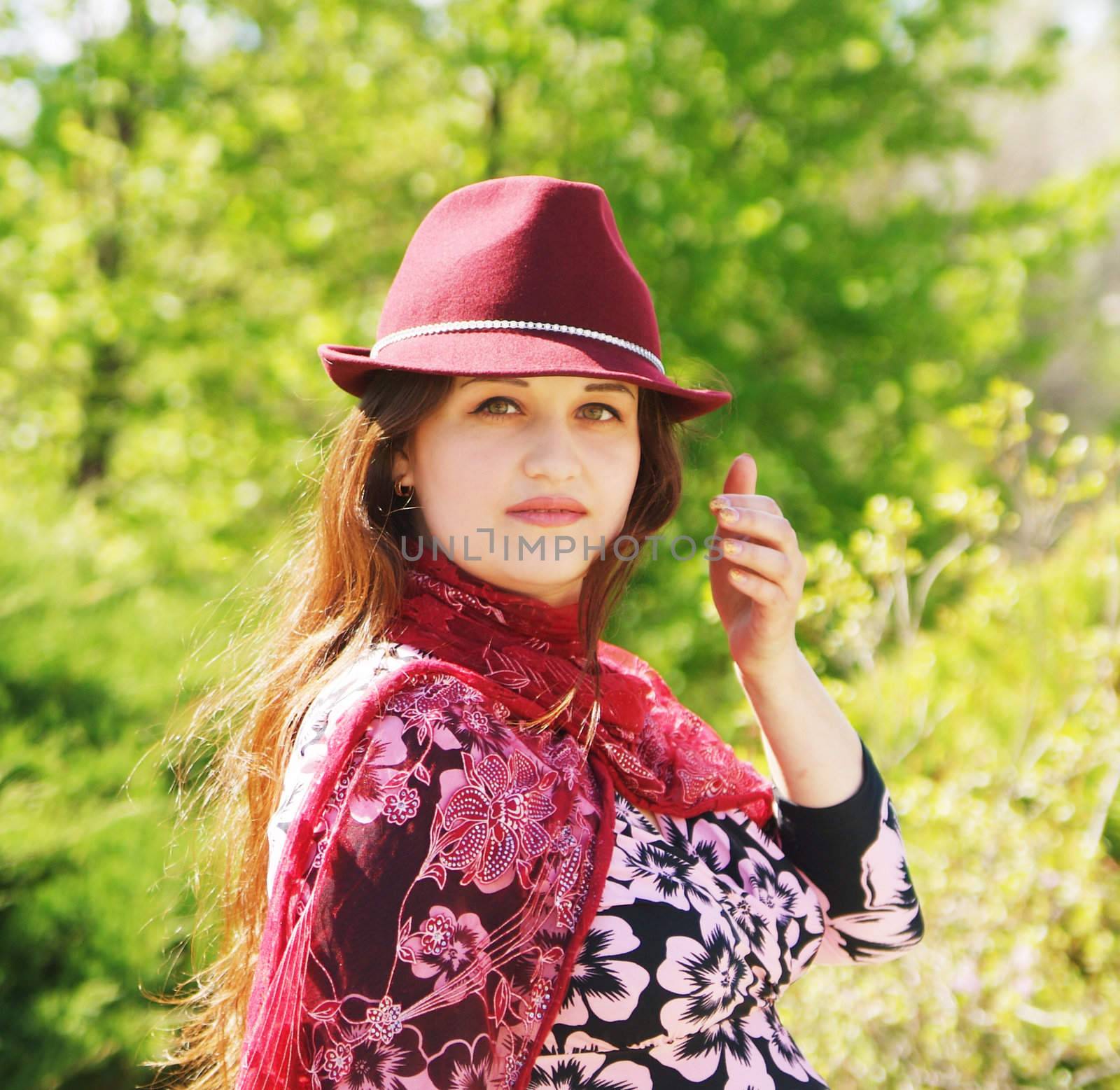 Women in bordo hat on the park