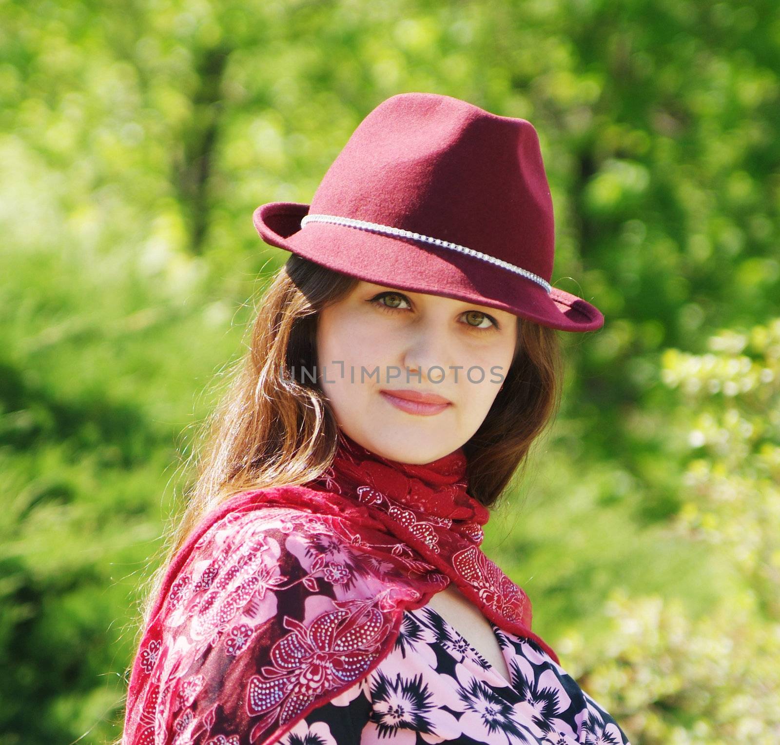 Women in bordo hat on the park by palomnik