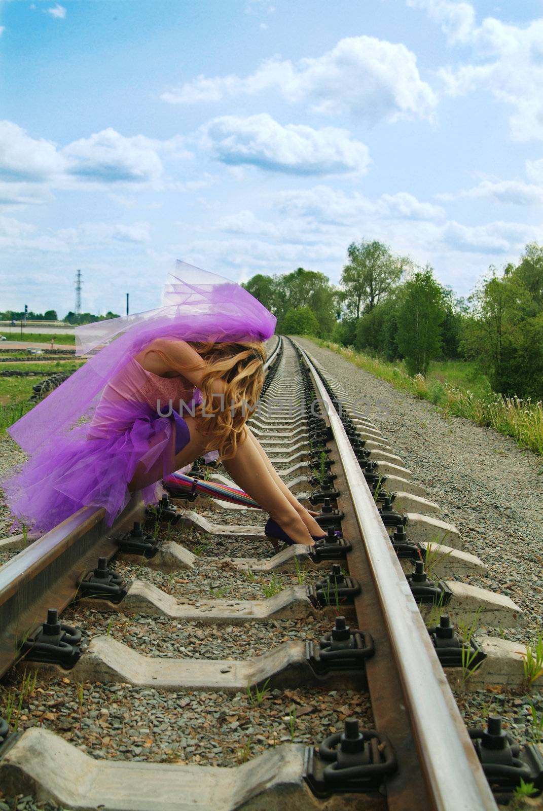 beauty girl sitting on the rail by palomnik