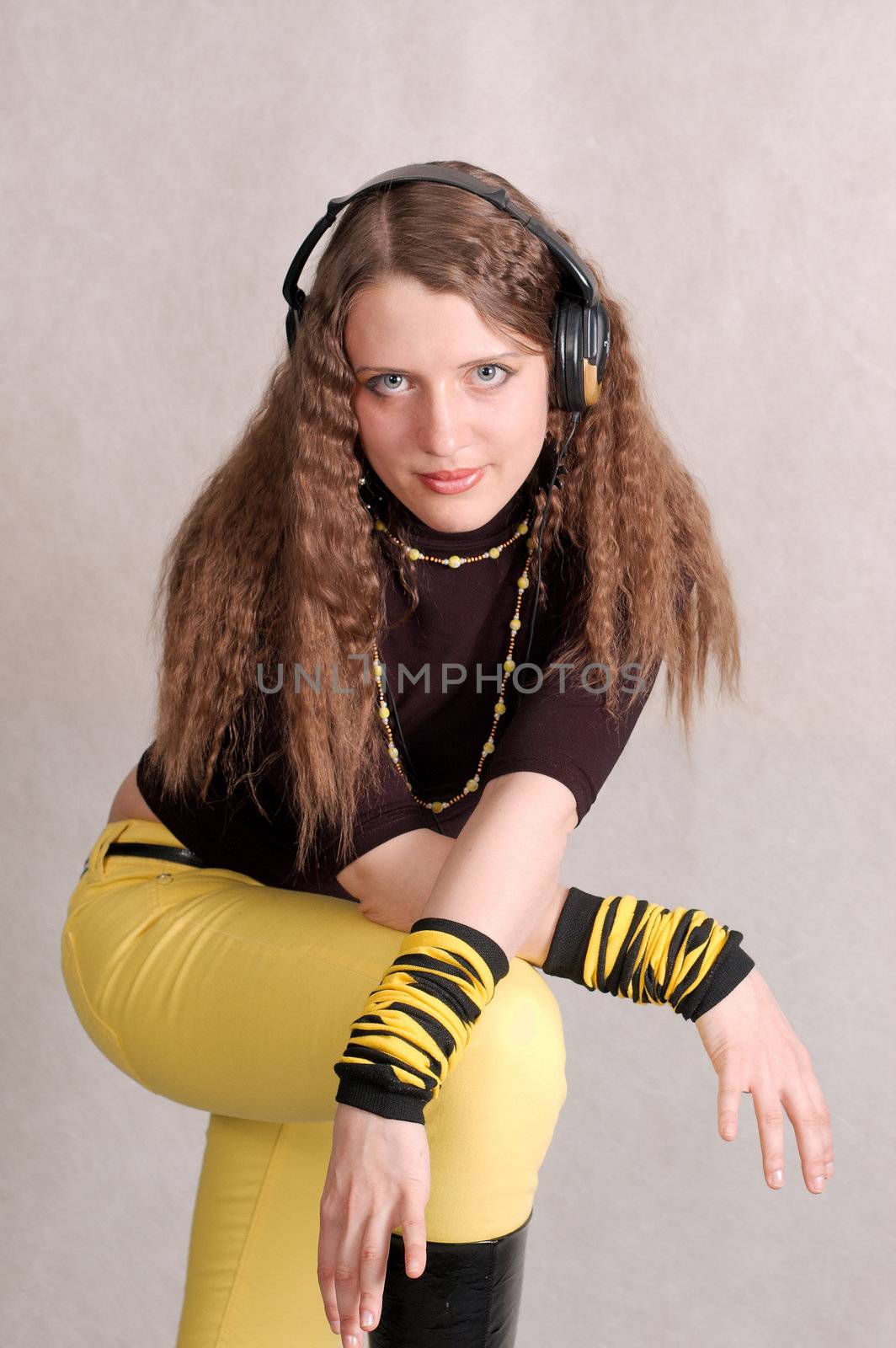 Curly woman with headphone in the studio by palomnik