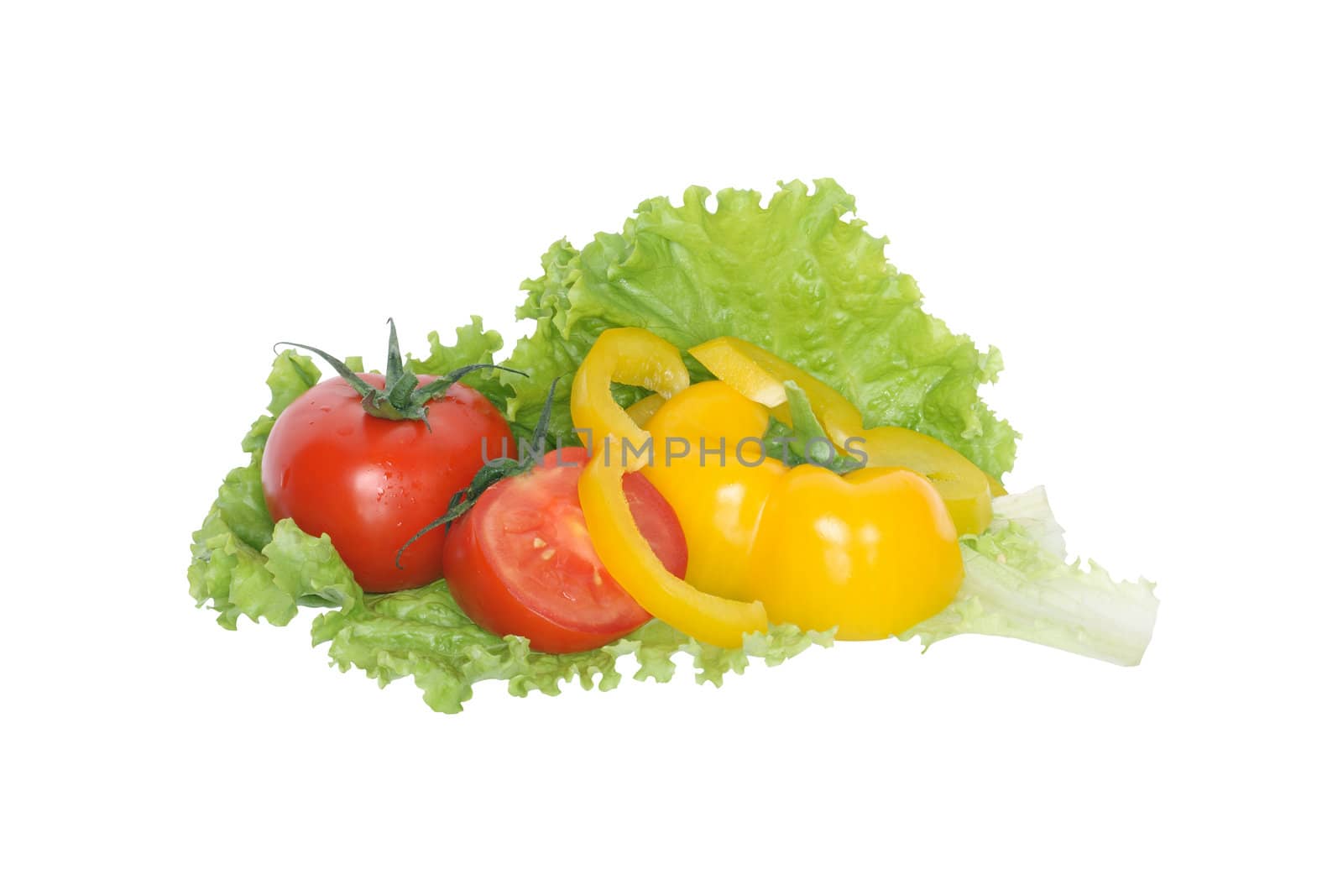 Sliced sweet pepper and tomatoes lying on green lettuce. Isolated on white background with clipping path