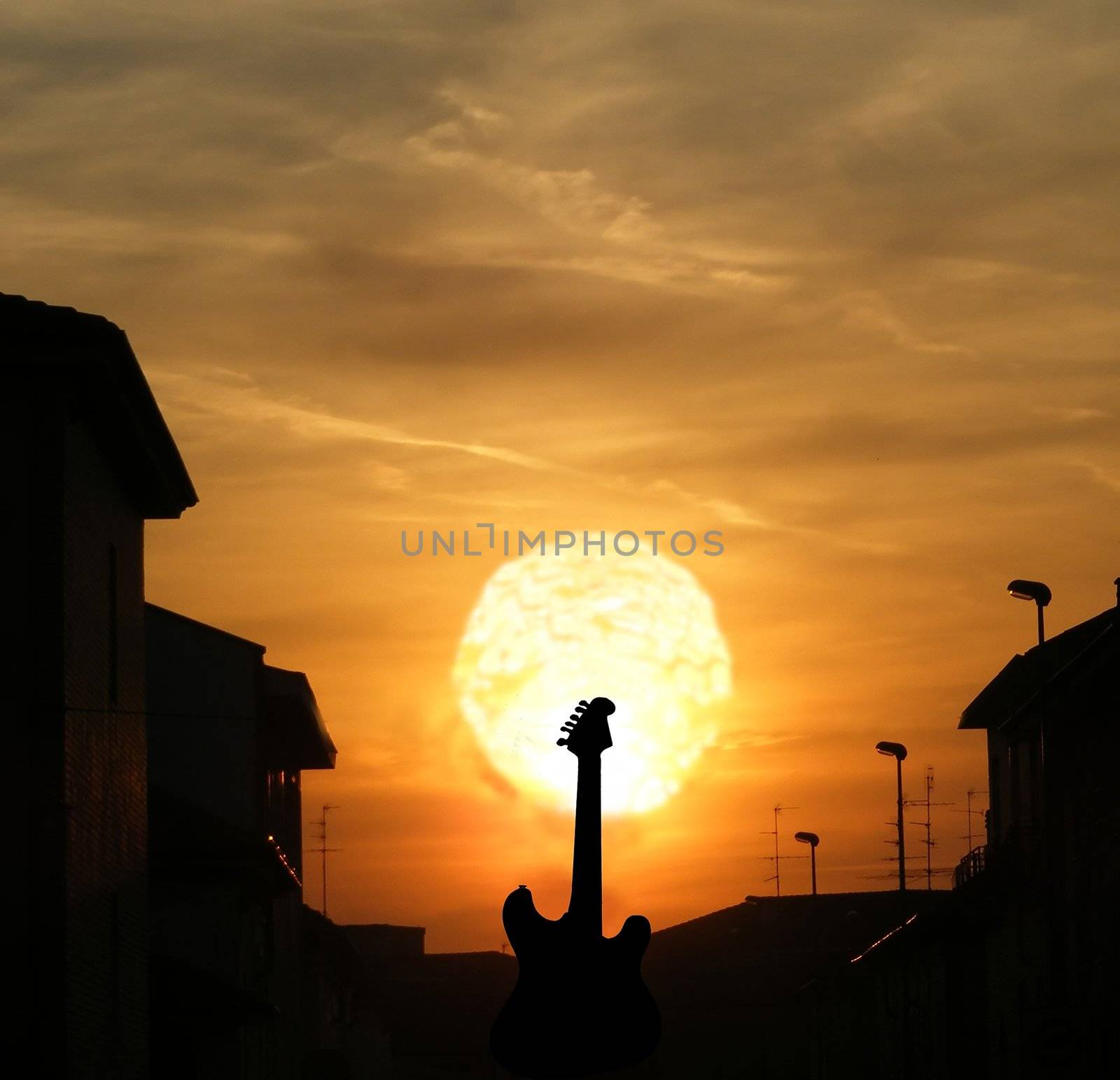 Sunset on the black silhouette of an electric guitar