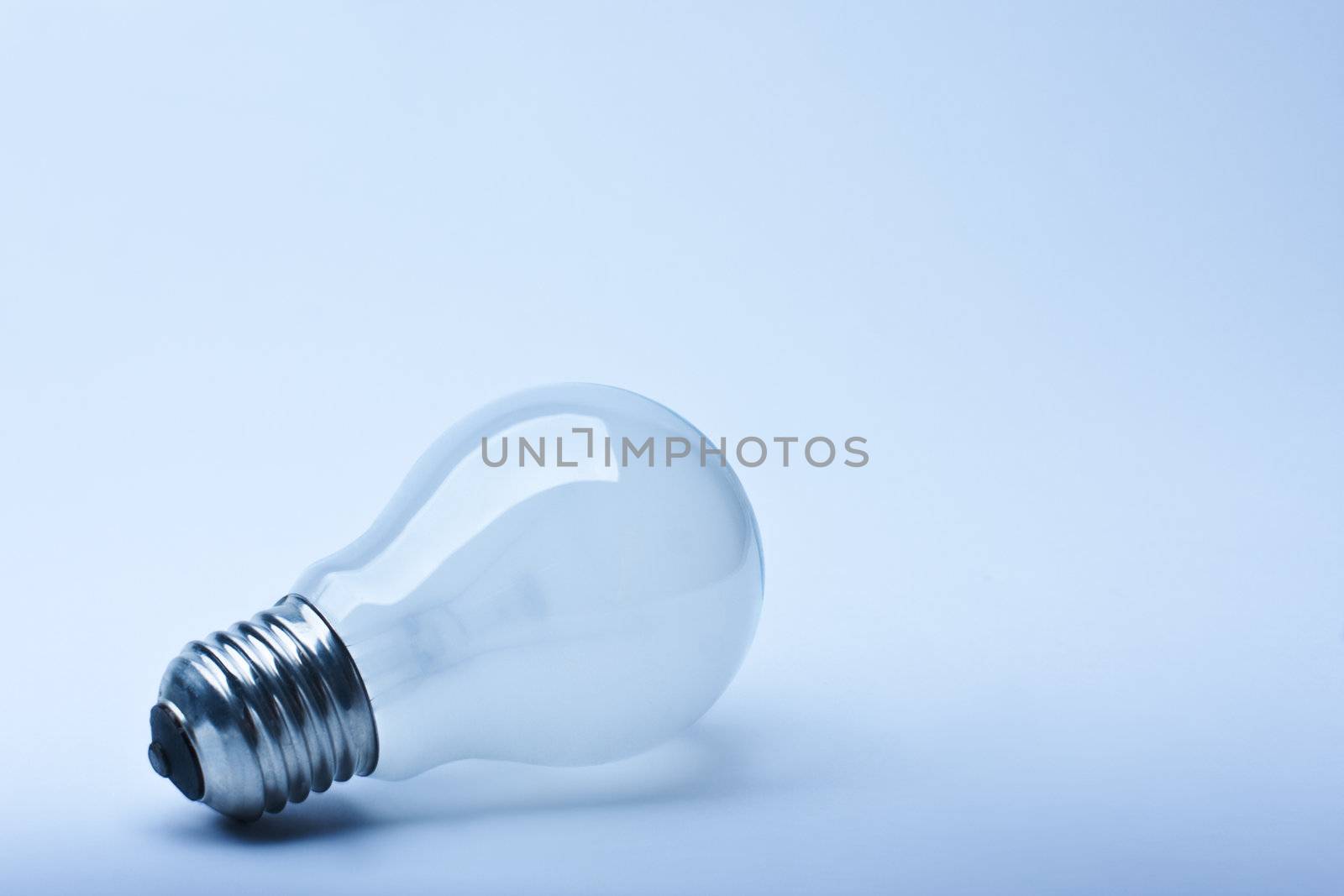 Close-up isolated light bulb in blue lighting