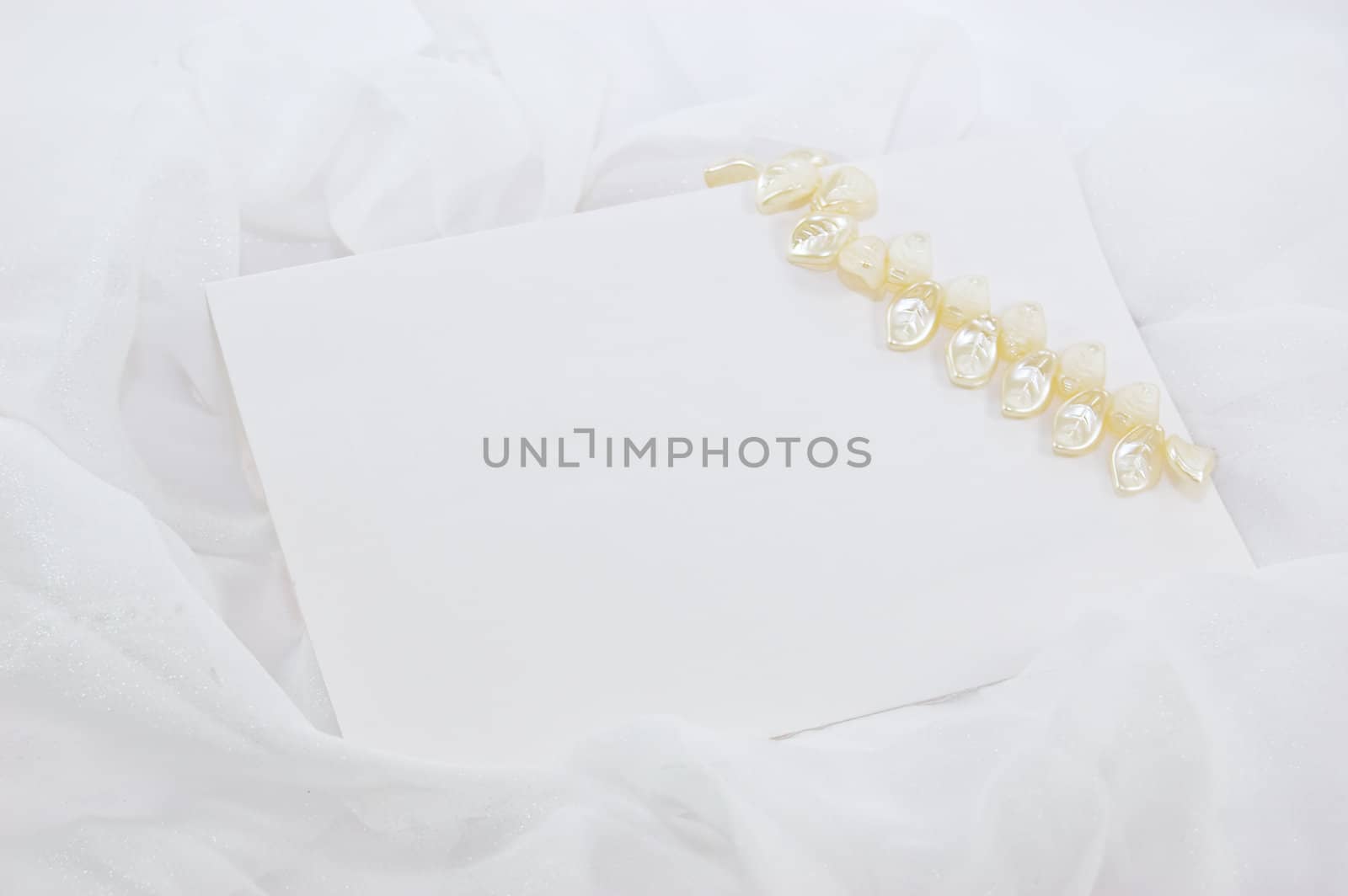 blank note with decoration over white fabric