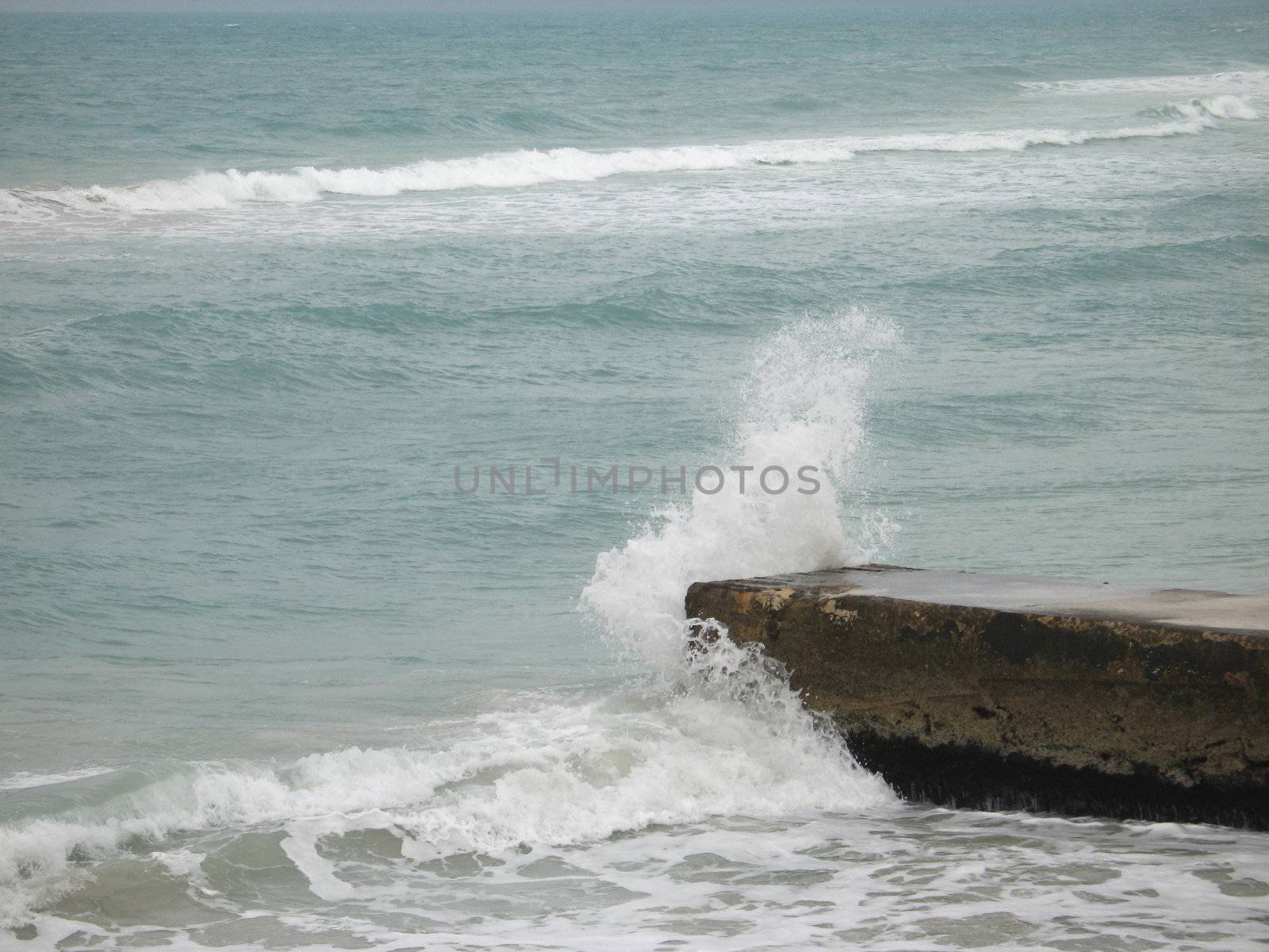 wave crashing on a dock