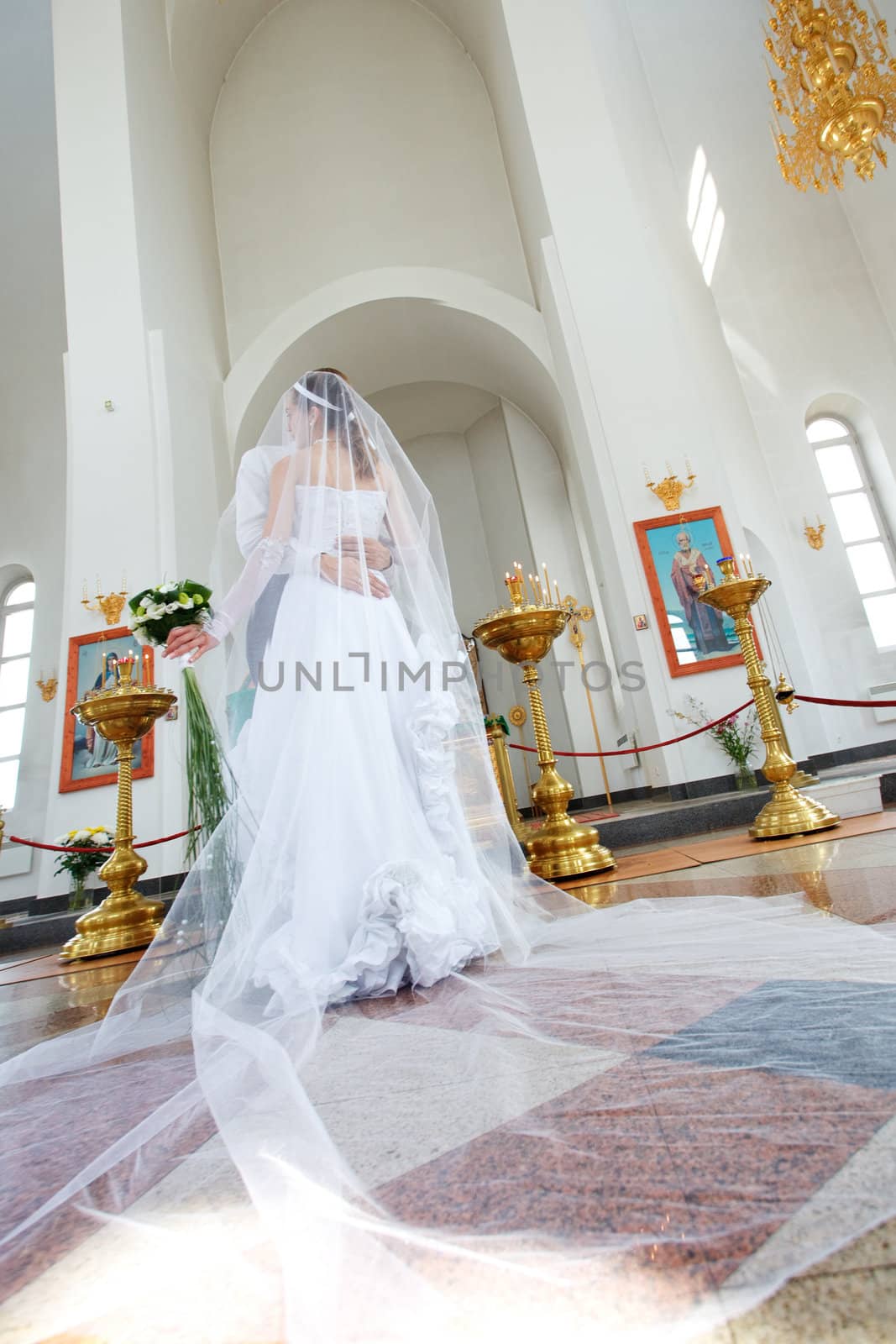 bride and groom in the church by vsurkov