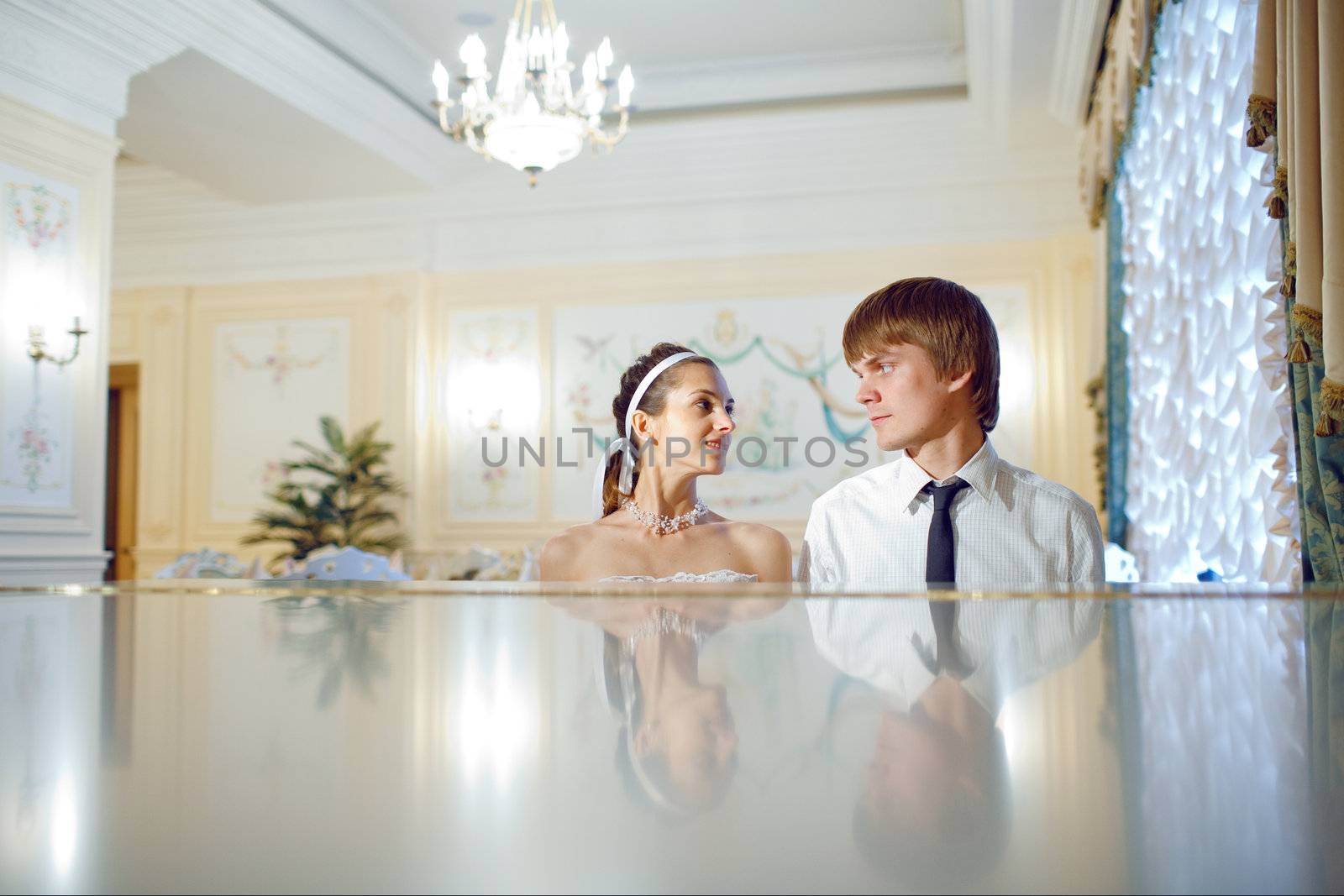 looks at the piano of bride and groom