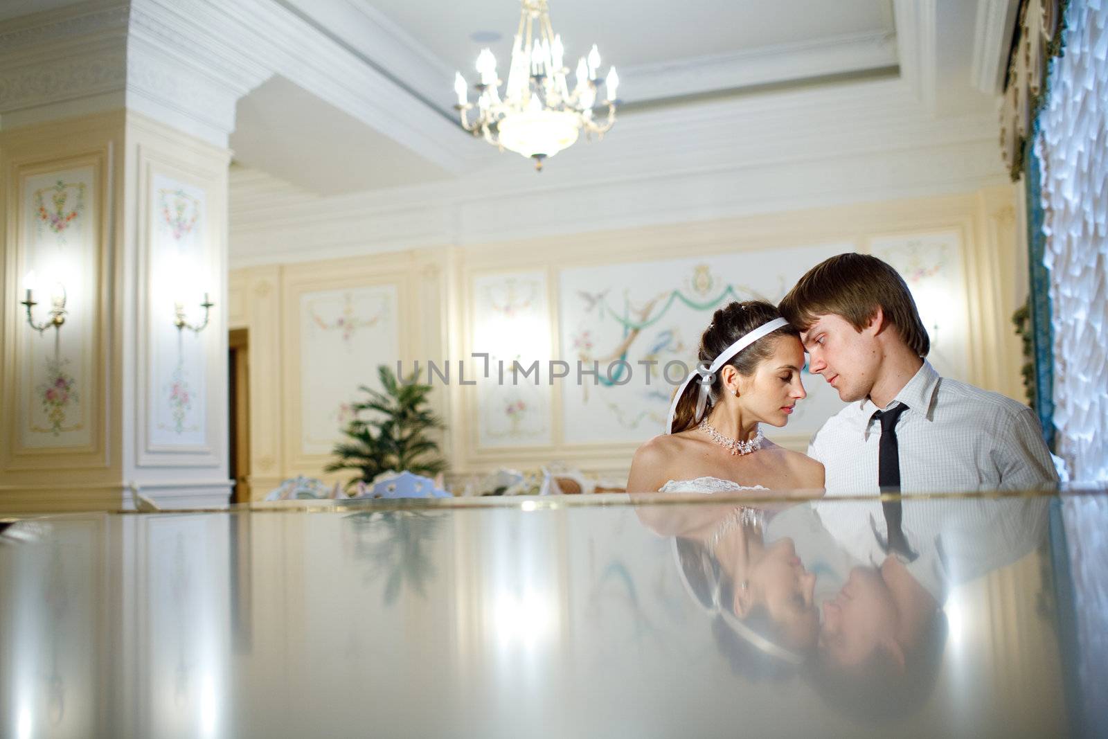 happy bride and groom at the piano