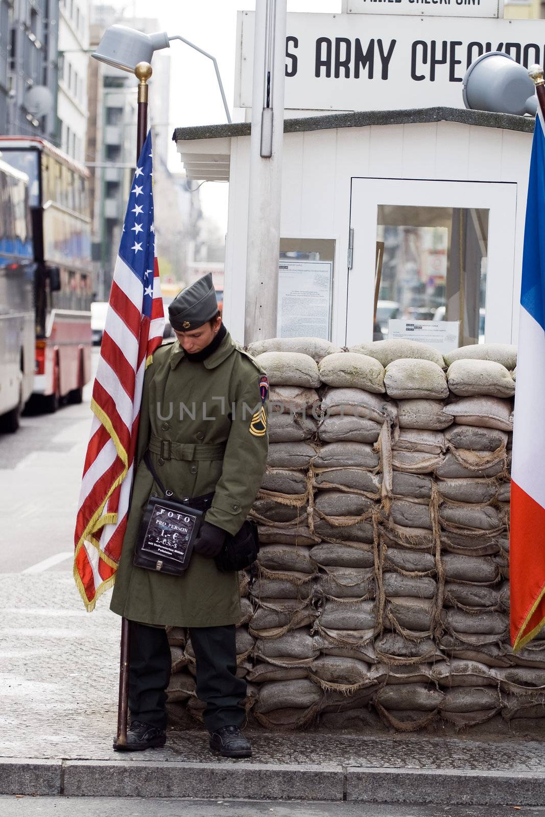 Soldier with American flag at Checkpoint Charlie. Berlin, Germany, april 14, 2008