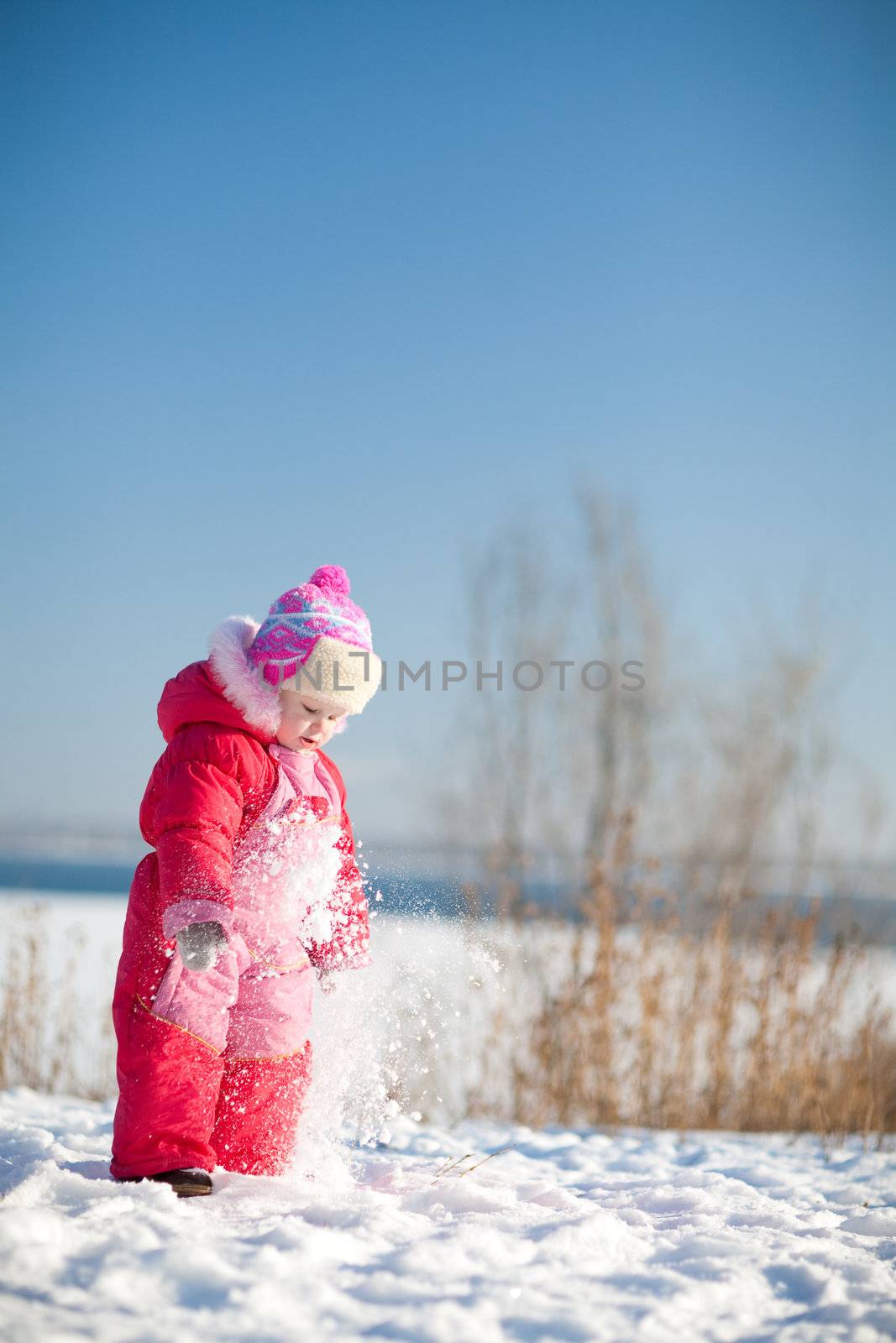 small child playing in winter