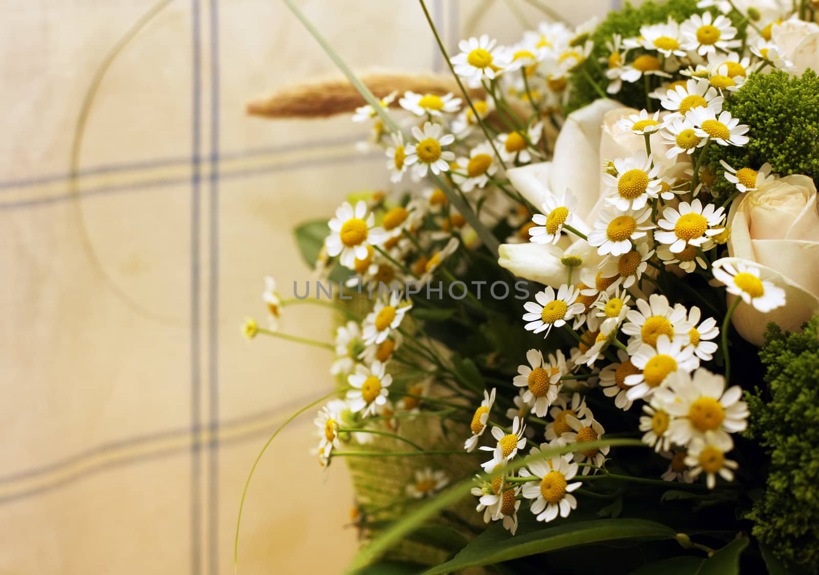 Bouquet from small camomiles and roses 