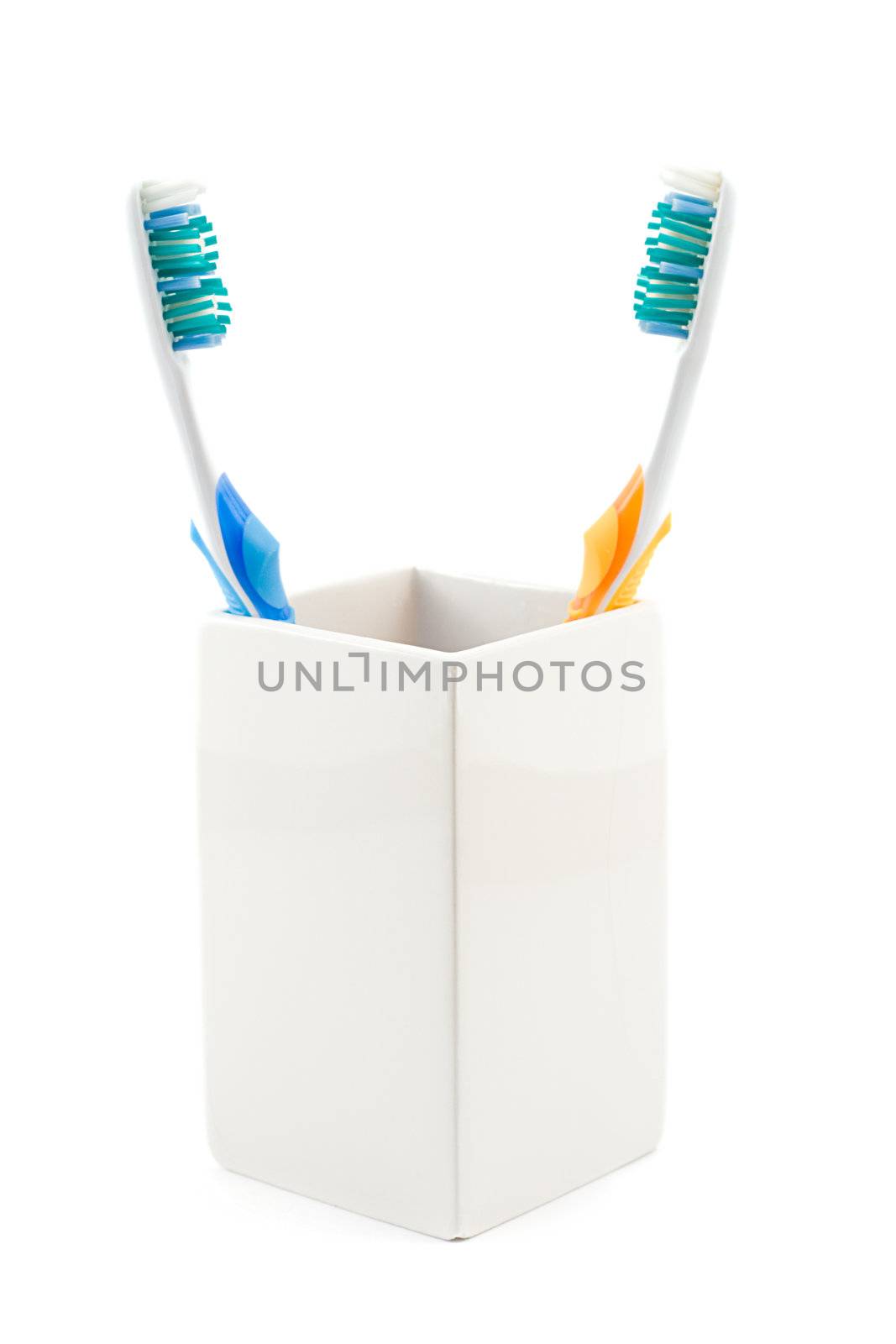 toothbrushes in cup, shot on white