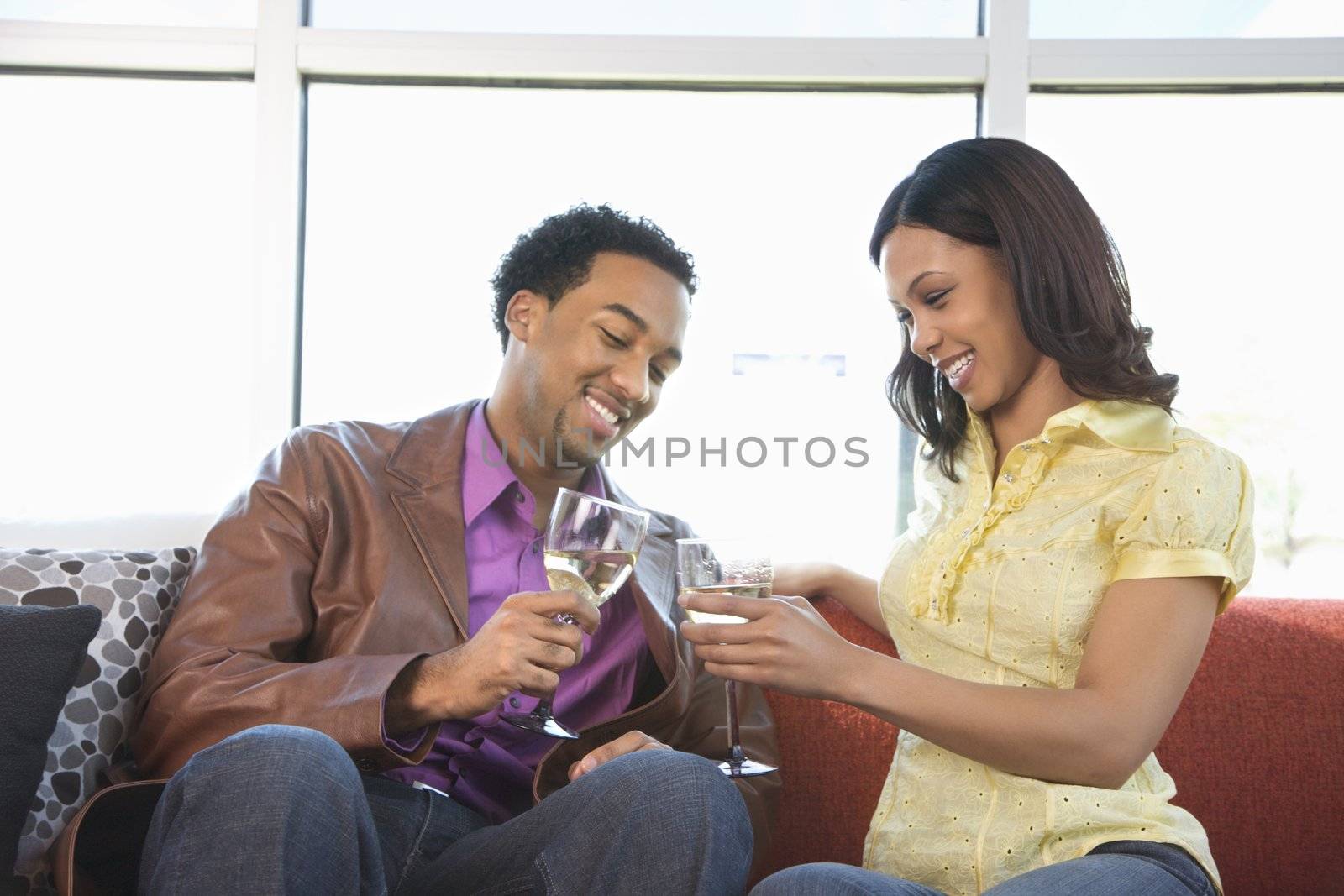 African American couple toasting with wine glasses.