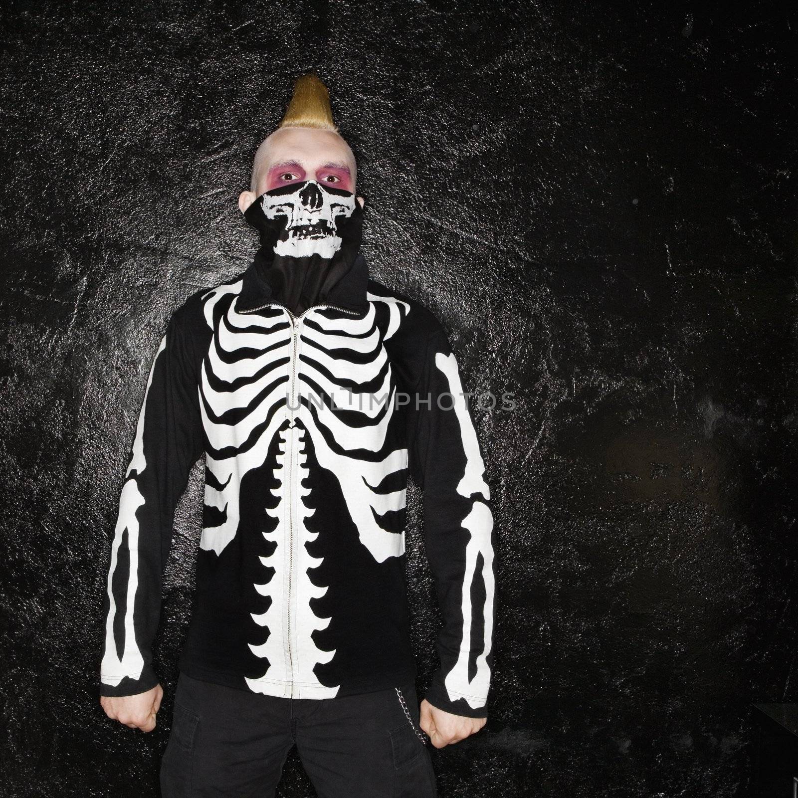 Mid-adult Caucasian male punk wearing skeleton sweatshirt and skeleton bandanna.