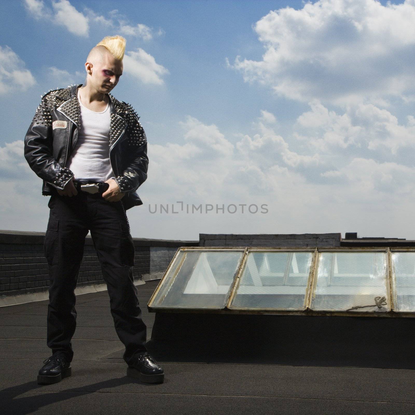 Punk standing on roof. by iofoto