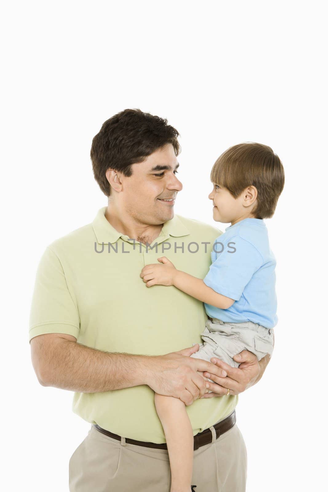 Portrait of father holding son against white background.