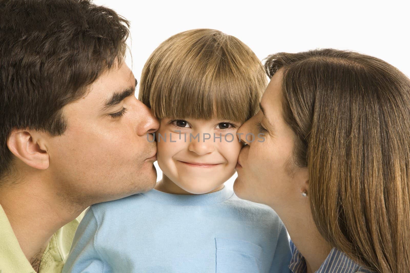 Parents kissing son. by iofoto