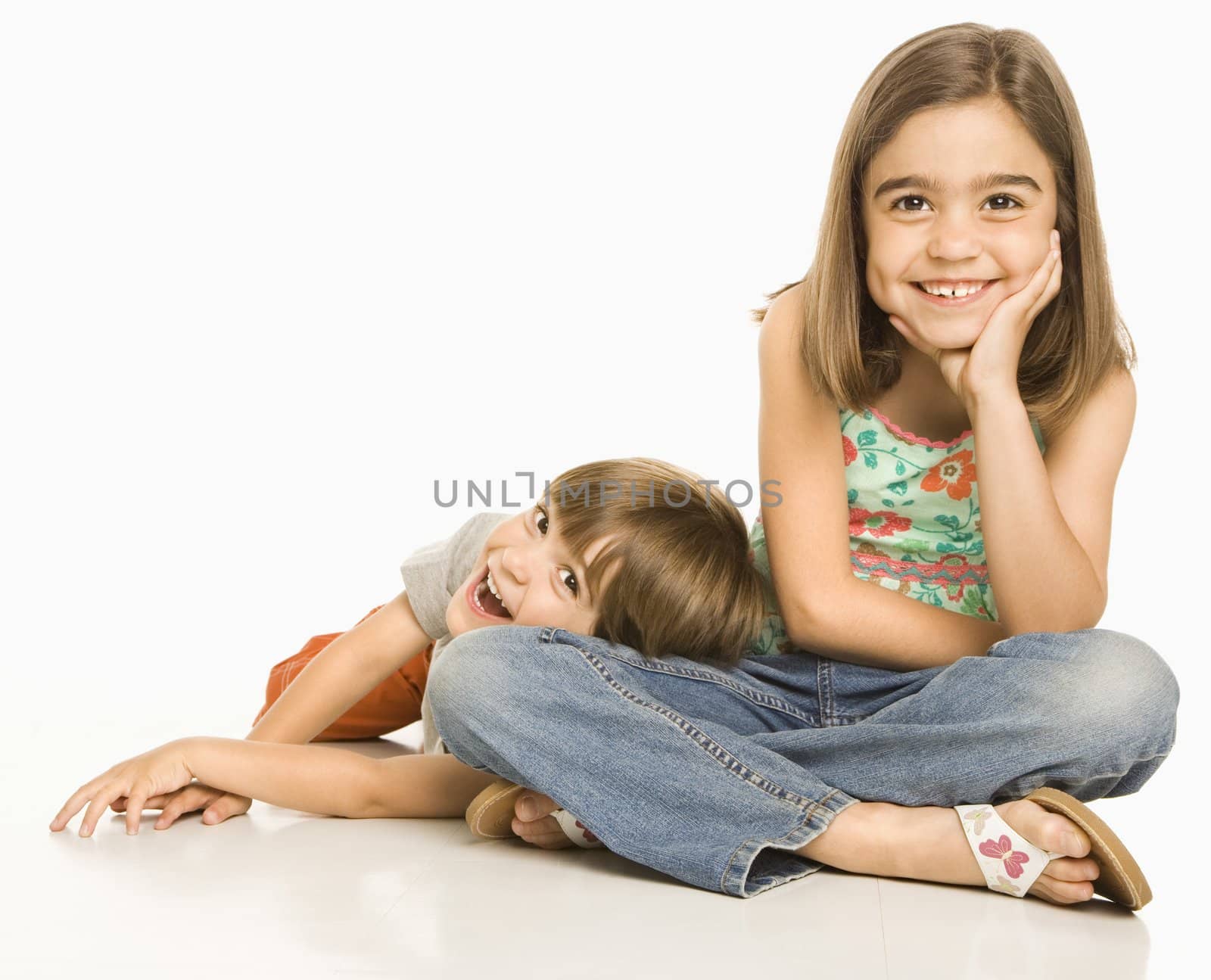 Portrait of girl and boy against white background.