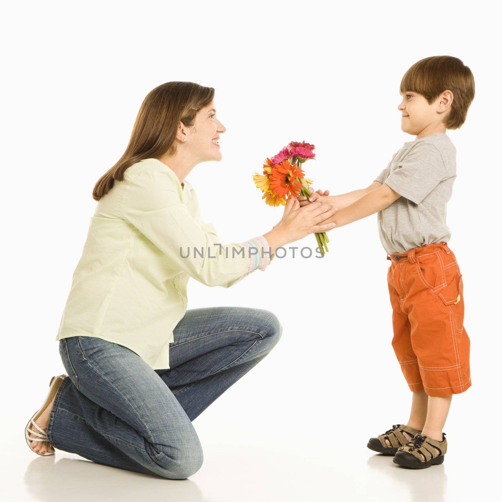 Son giving bouquet of flowers to mother.