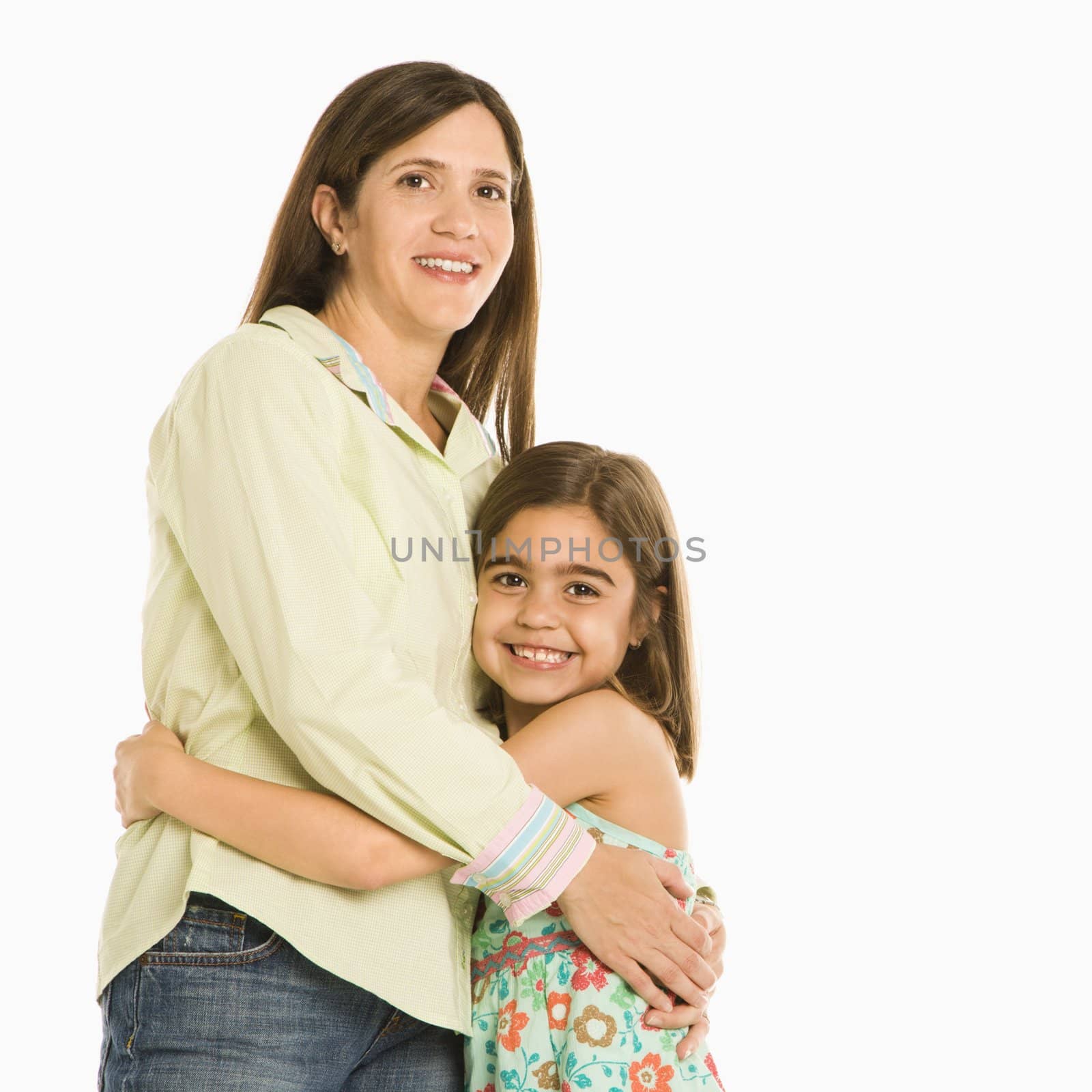 Mother and daughter standing holding eachother smiling.