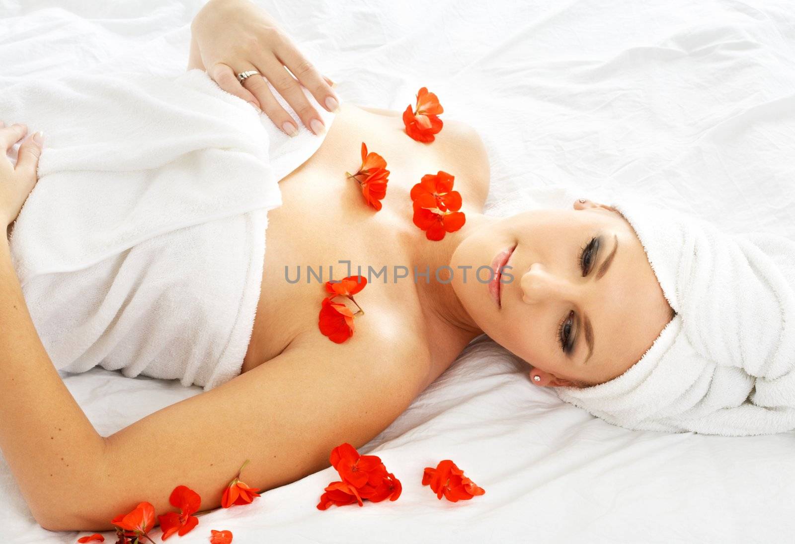 beautiful lady with red flower in spa