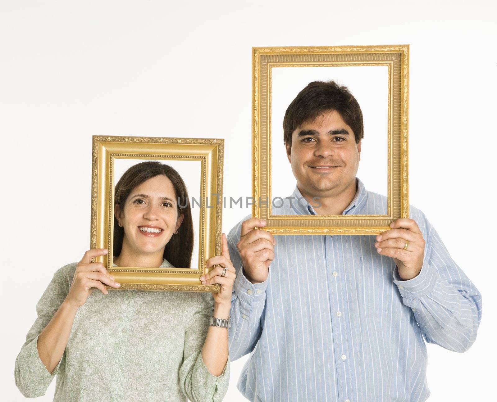 Man and woman looking through empty frames.