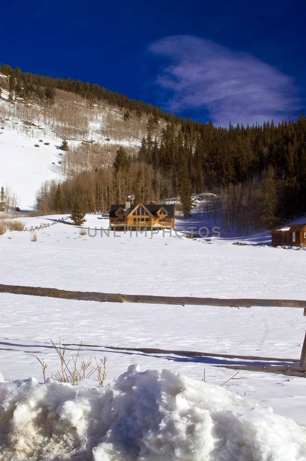 Log Cabin Mansions In Snow in Colorado by jdebordphoto