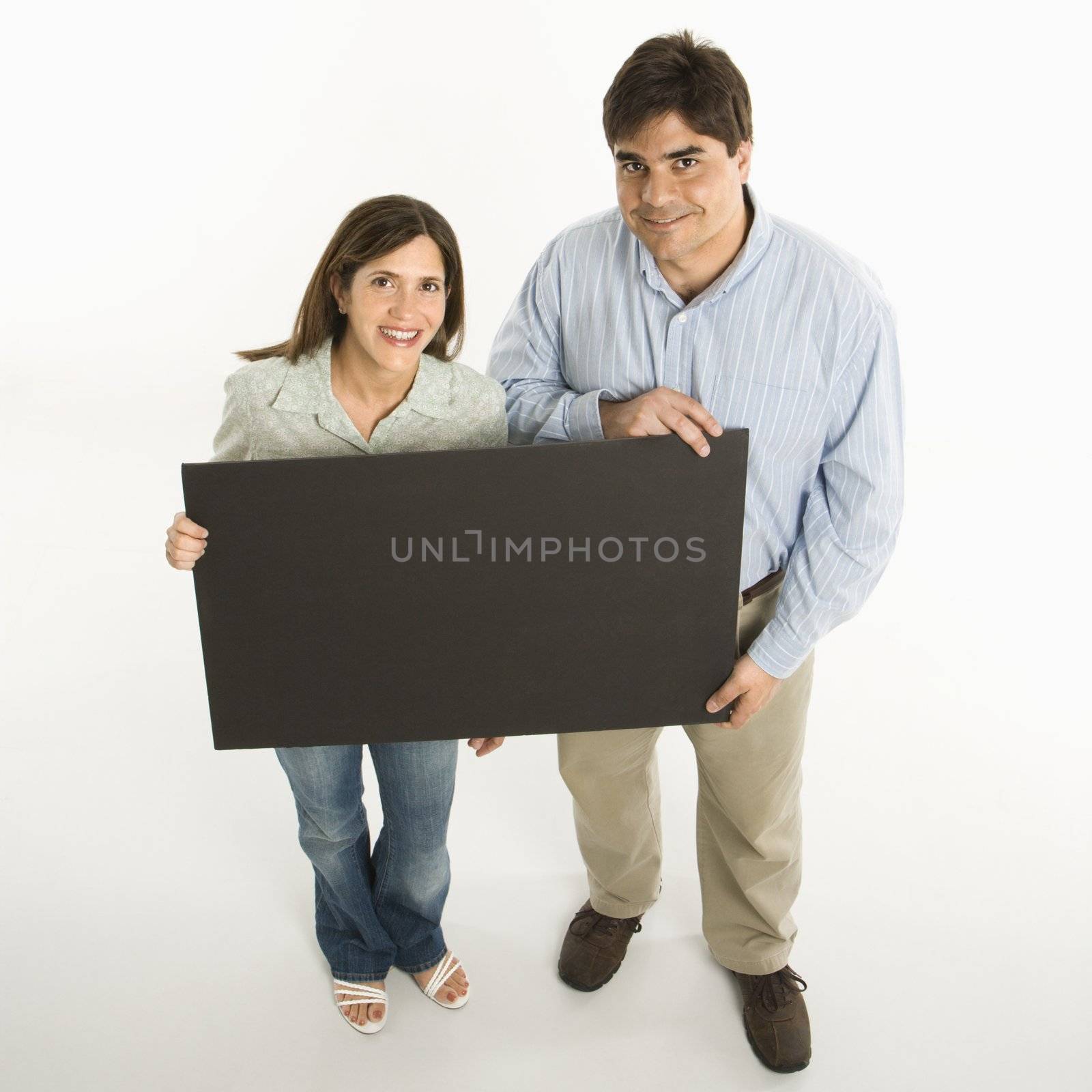 Couple holding blank sign. by iofoto