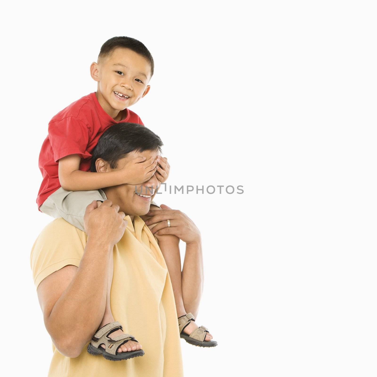 Son on dad's shoulders. by iofoto