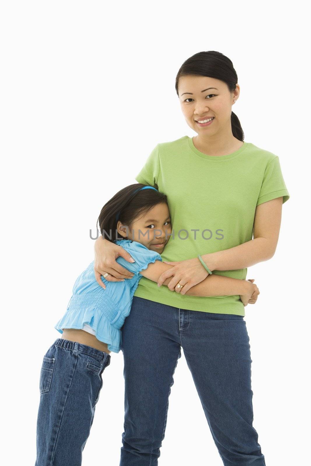 Asian mother and daughter standing with arms around eachother.