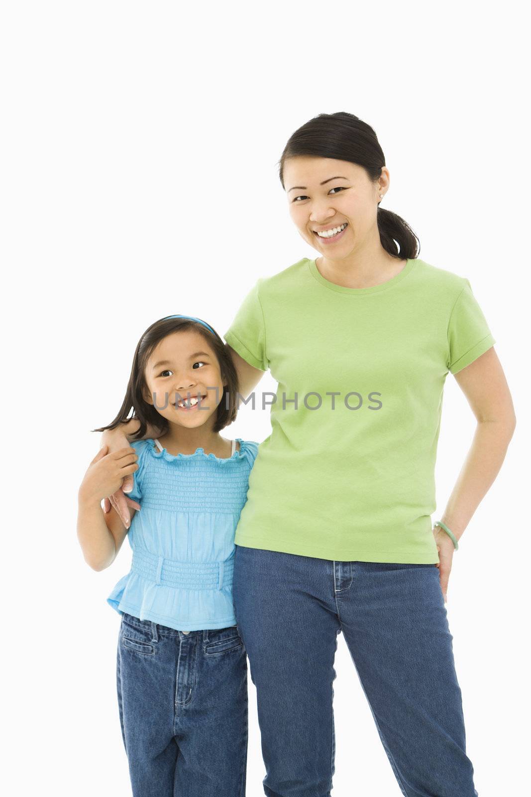 Asian mother and daughter standing with arms around eachother.