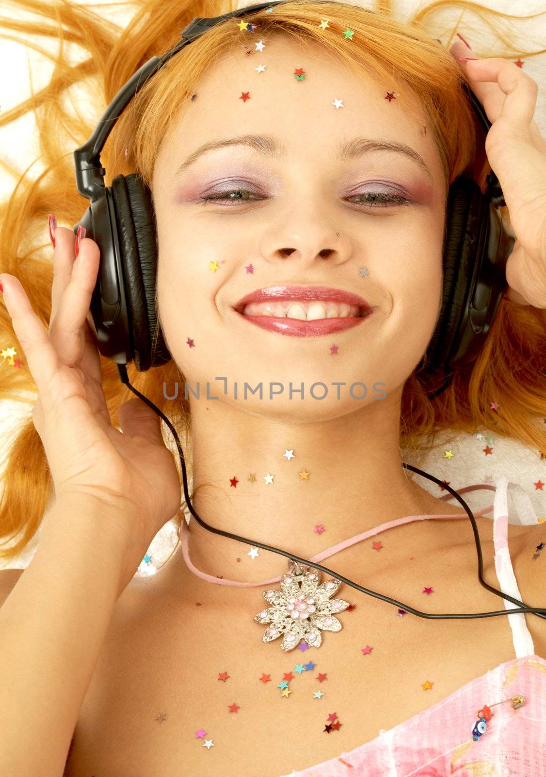 image of smiling redhead listening music