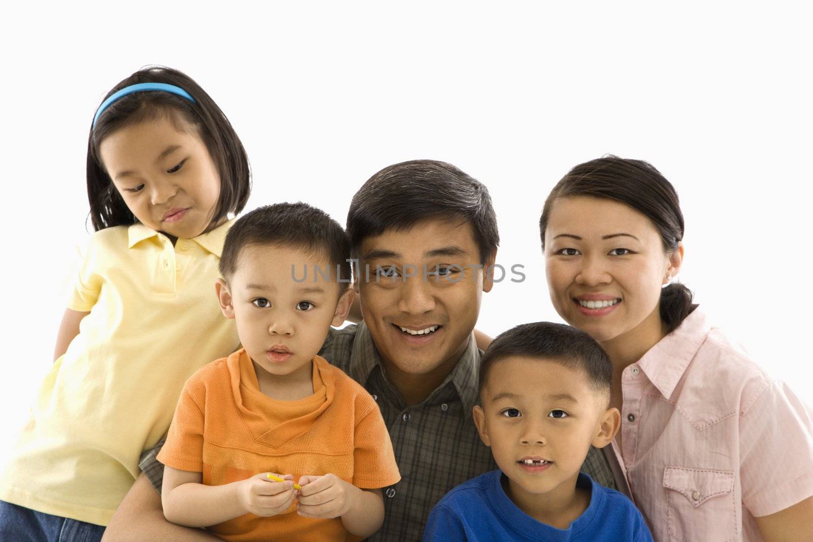 Asian family portrait against white background.