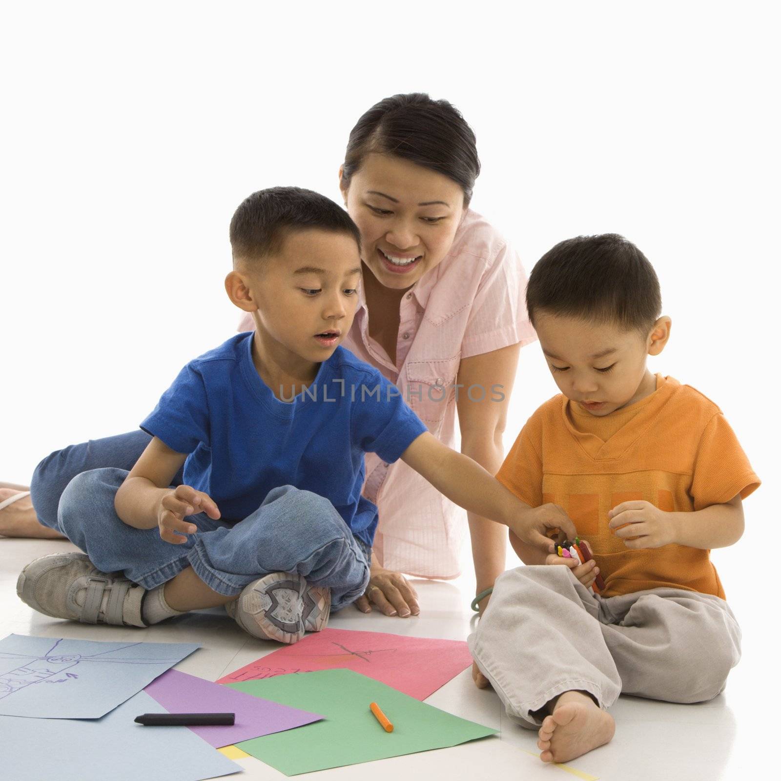 Boys coloring with mother. by iofoto