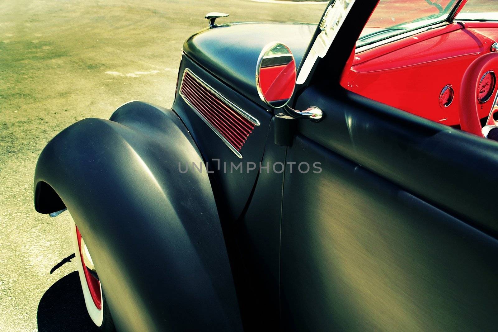 A black primered hotrod with red interior