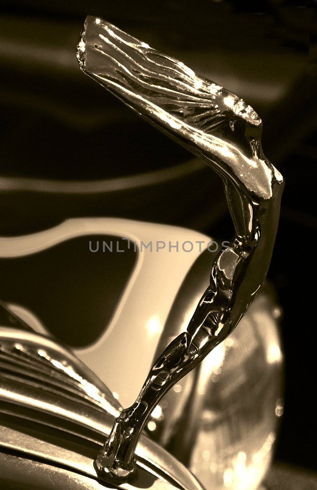 A elegant hood ornament on a hotrod in sepia