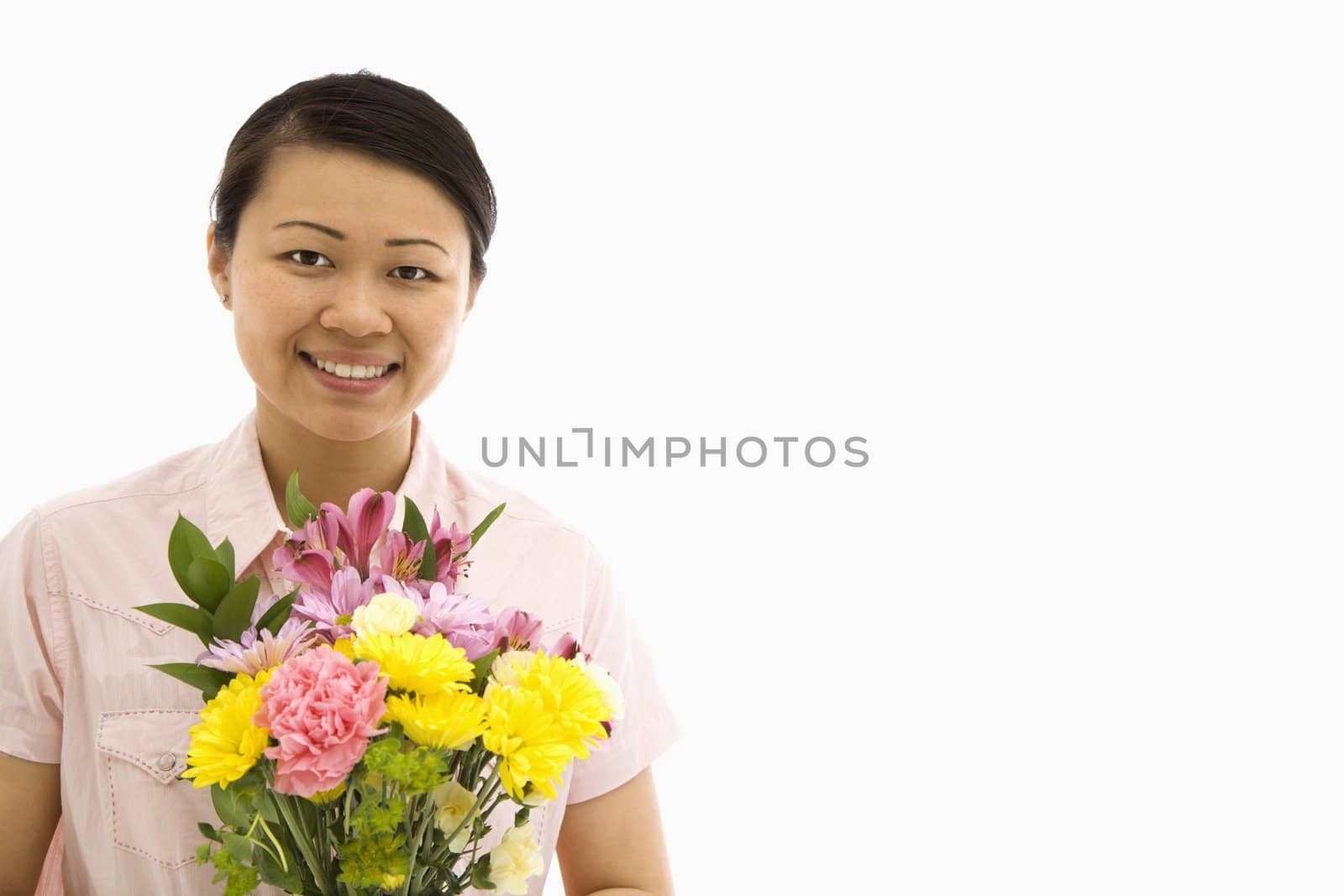 Mid adult Asian woman holding bouquet of flowers.