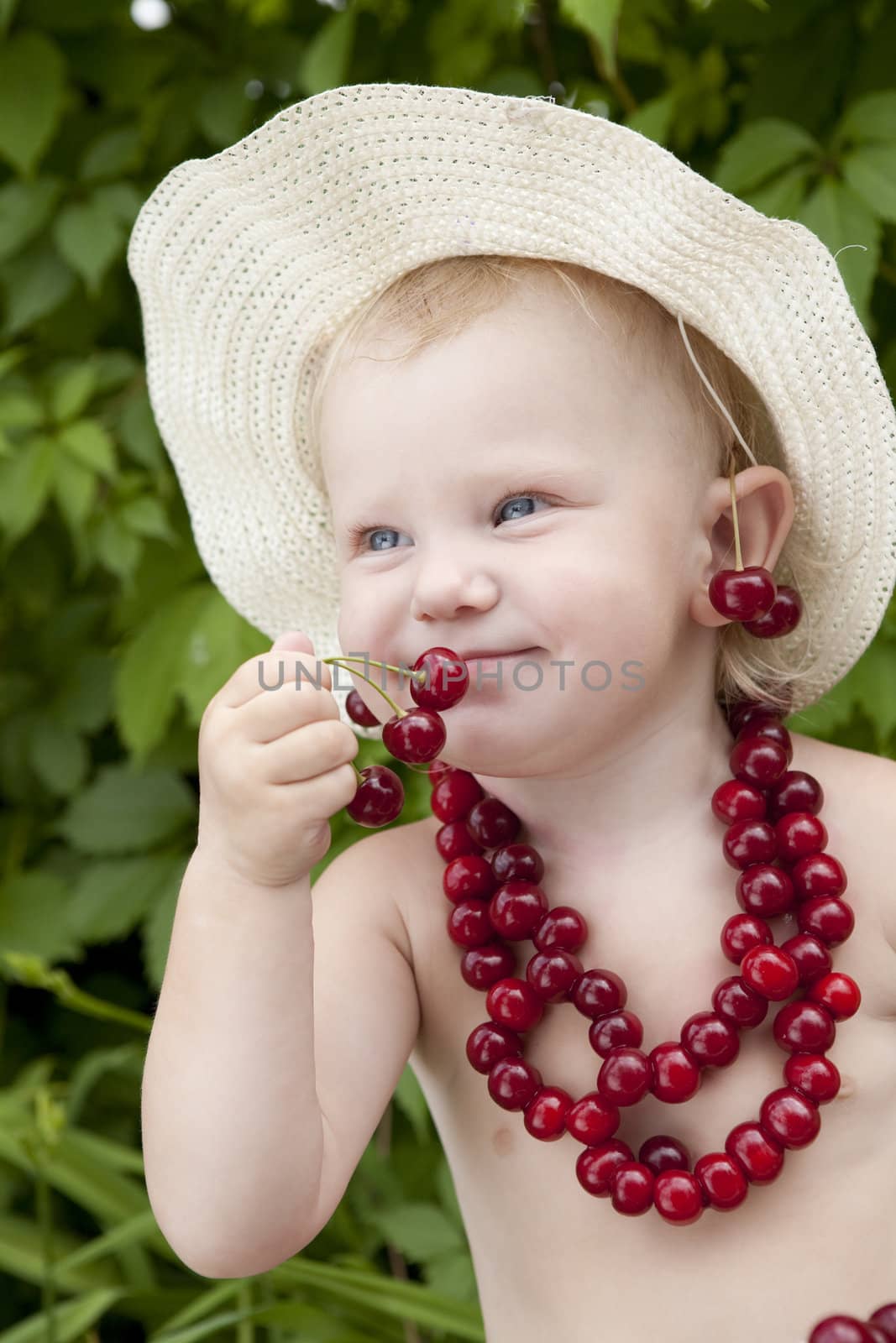 small girl with red cherry beads and earrings
