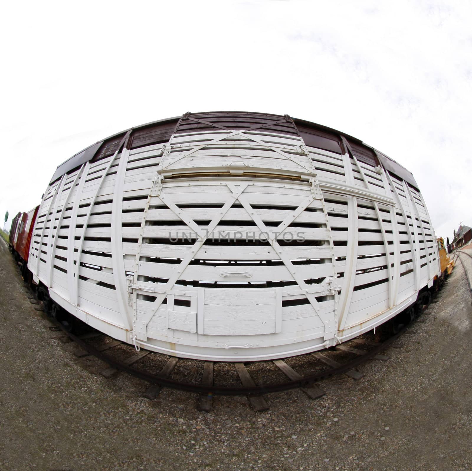 Old white railway car through fish eye